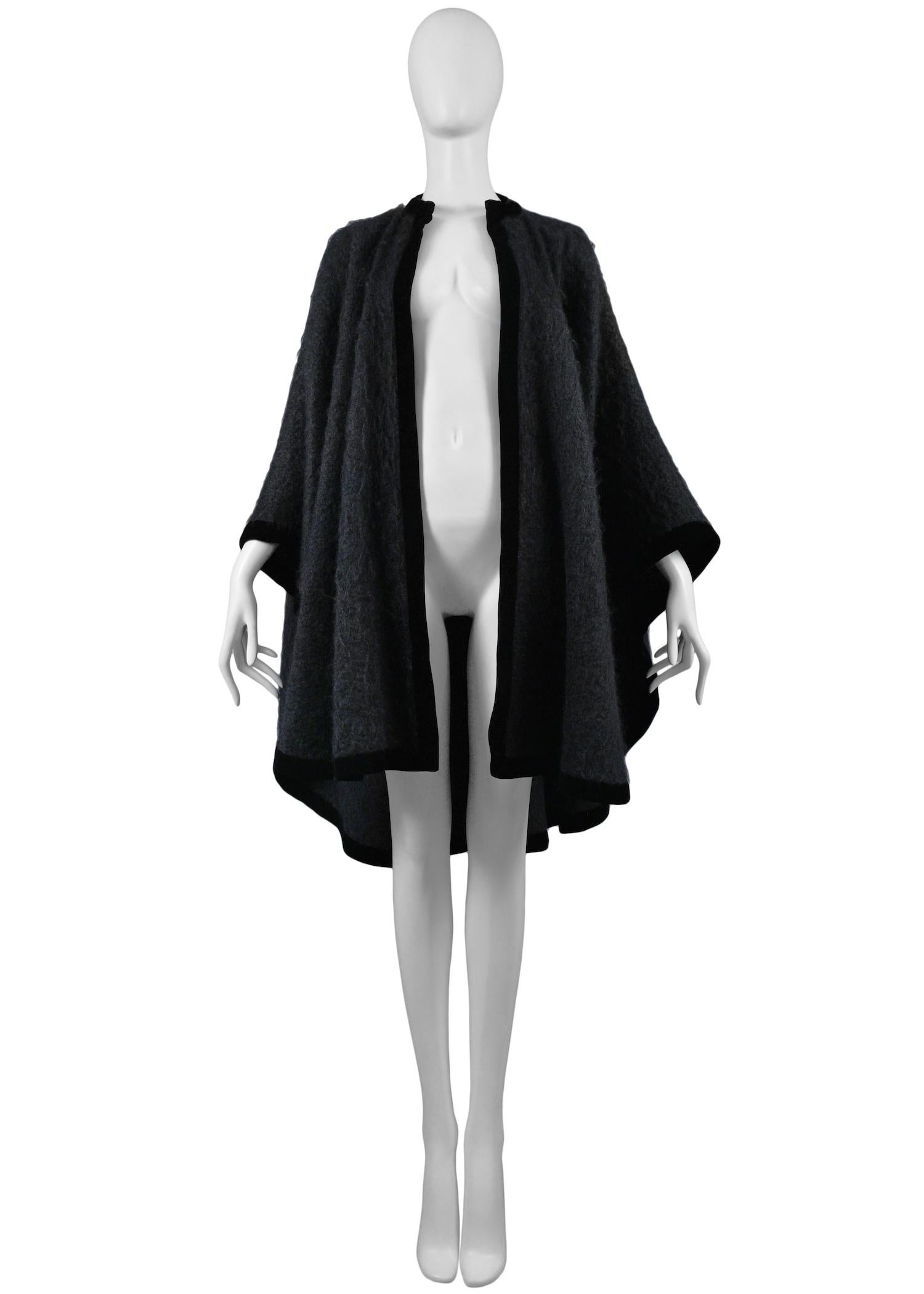 Vintage Yves Saint Laurent black mohair cape featuring velvet trim around the edges. Circa 1965.

Excellent Vintage Condition.

One Size
