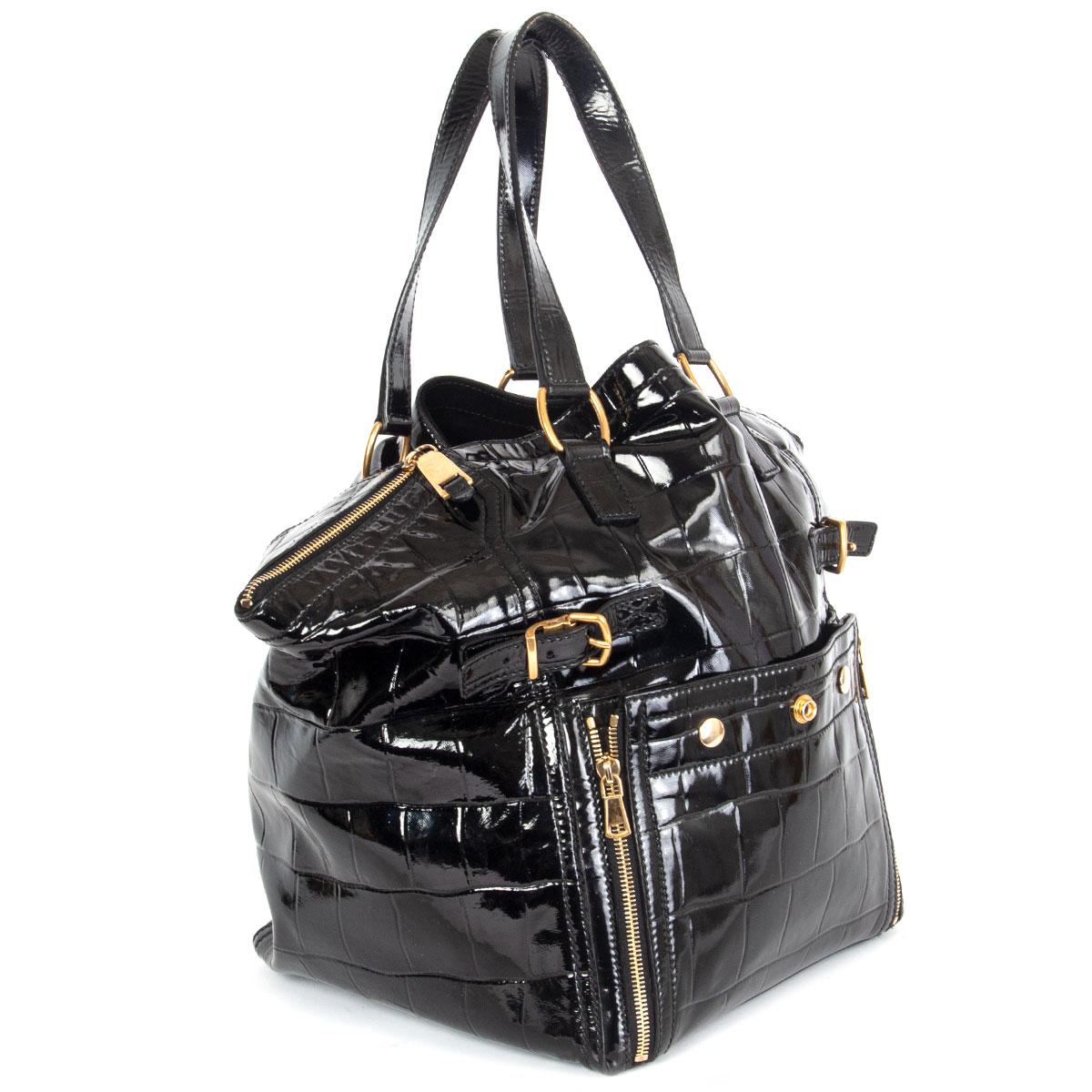 100% authentic Yves Saint Laurent 'Downtown Paris' tote bag in black crocodile embossed calfskin patent leather featuring gold-tone hardware. It has two top handles, hand pressed rivets, a patch pocket in front with zippers that allow expansion, two