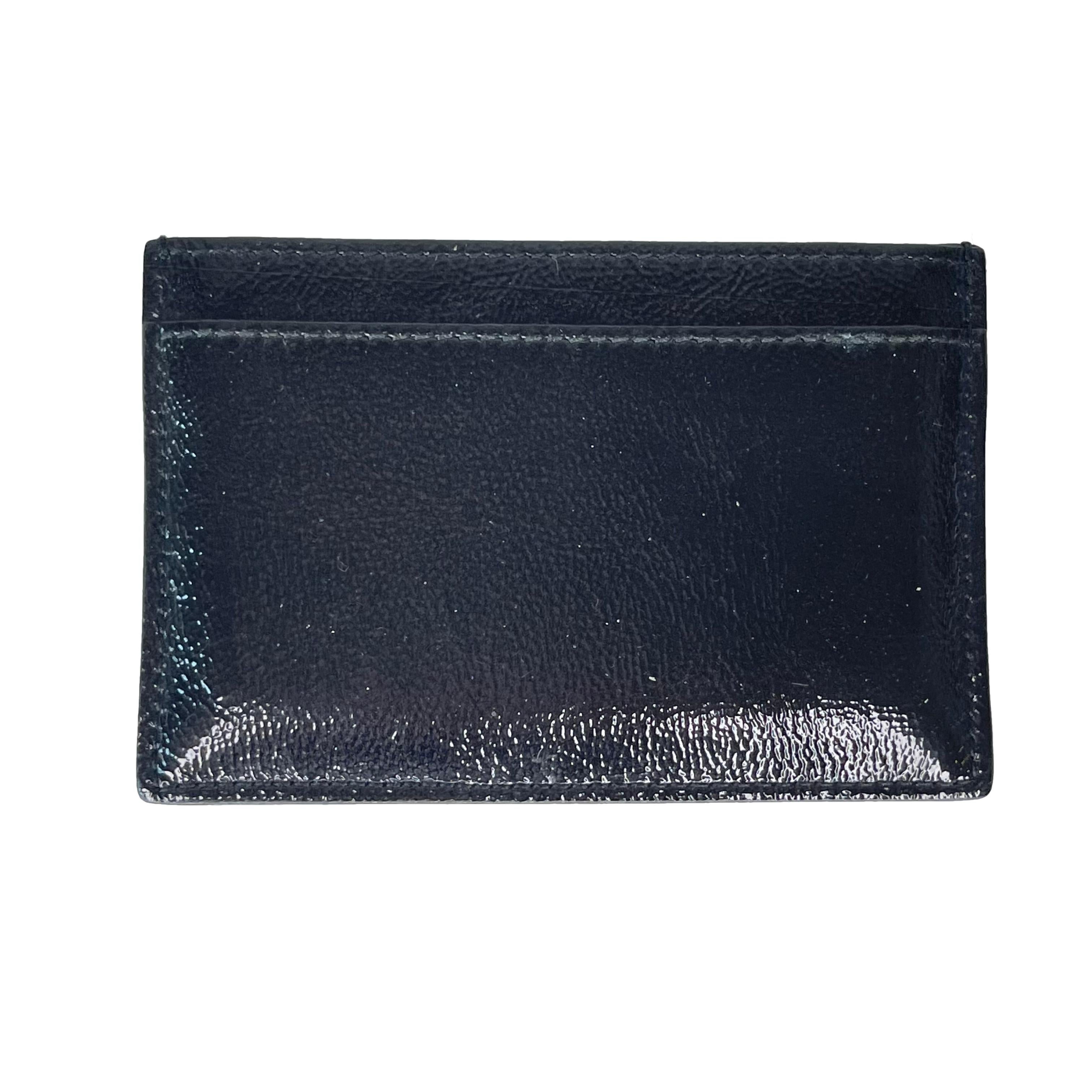 COLOR: Black
MATERIAL: Patent leather
ITEM CODE: 513092 211908
MEASURES: H 2” x L 3.5”
COMES WITH: Box and card card
CONDITION: Excellent - wallet is pristine.

Made in Italy