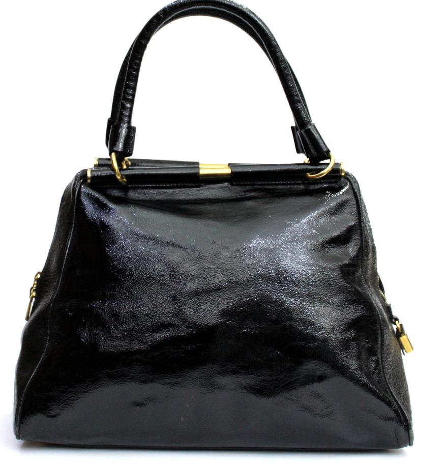 Yves Saint Laurent bag made of black gloss patent leather, with golden hardware. Double handle, zip closure.Internally large. Suitable for both day and evening.The bag is in good condition, with some signs of wear on the lower corners.
