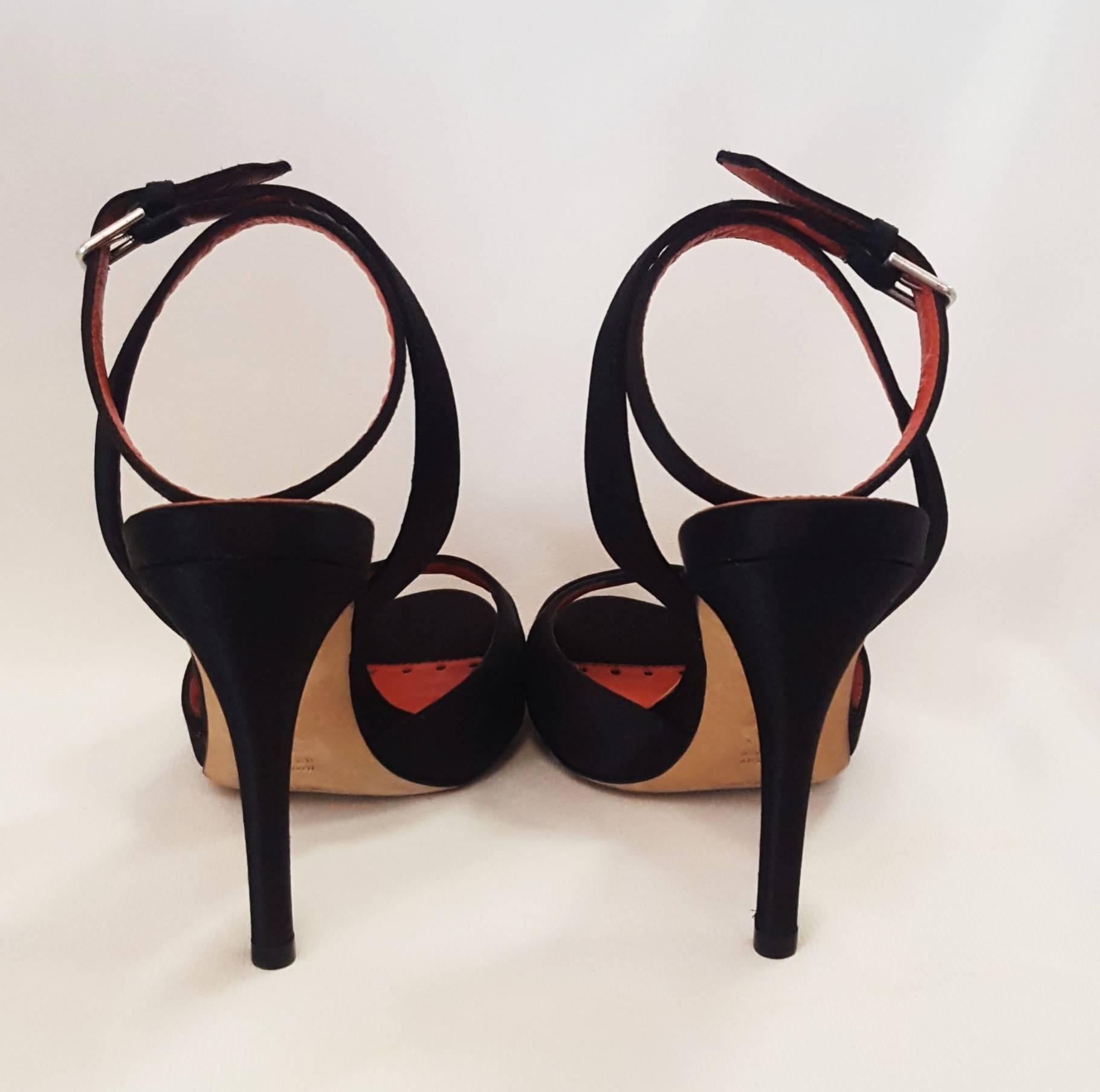 Yves Saint Laurent black satin with 4.5 heels with crisscross straps are perfect for an evening out or to dress up a pair of jeans.  These shoes are  lined in red leather and  have an ankle strap for added support, also, lined in red leather.  These
