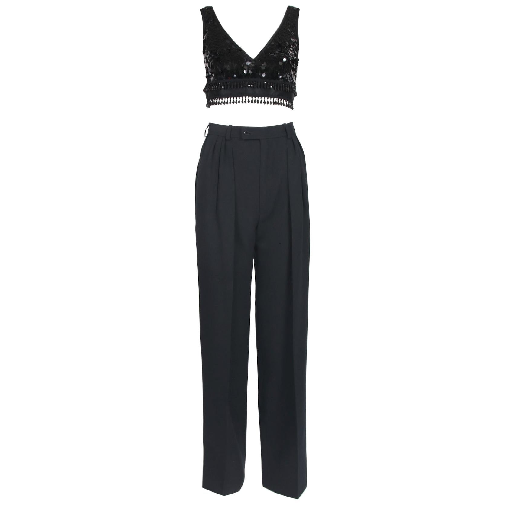 Yves Saint Laurent black smoking pants with sequin side stripe. There are several pleats at the front and back as well as two hidden side slash pockets. Size tag 38. There is no fabric tag but they feel like a wool gabardine. In excellent