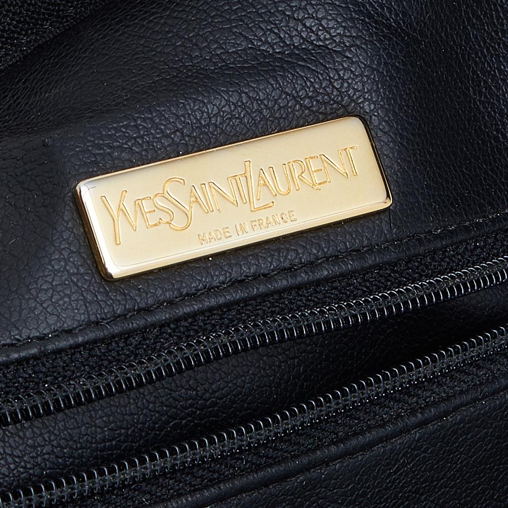 Made using black suede and leather, this Yves Saint Laurent satchel brings a convenient size and a refined appeal. It features two handles, YSL embroidery at the front, and a leather-lined interior.


