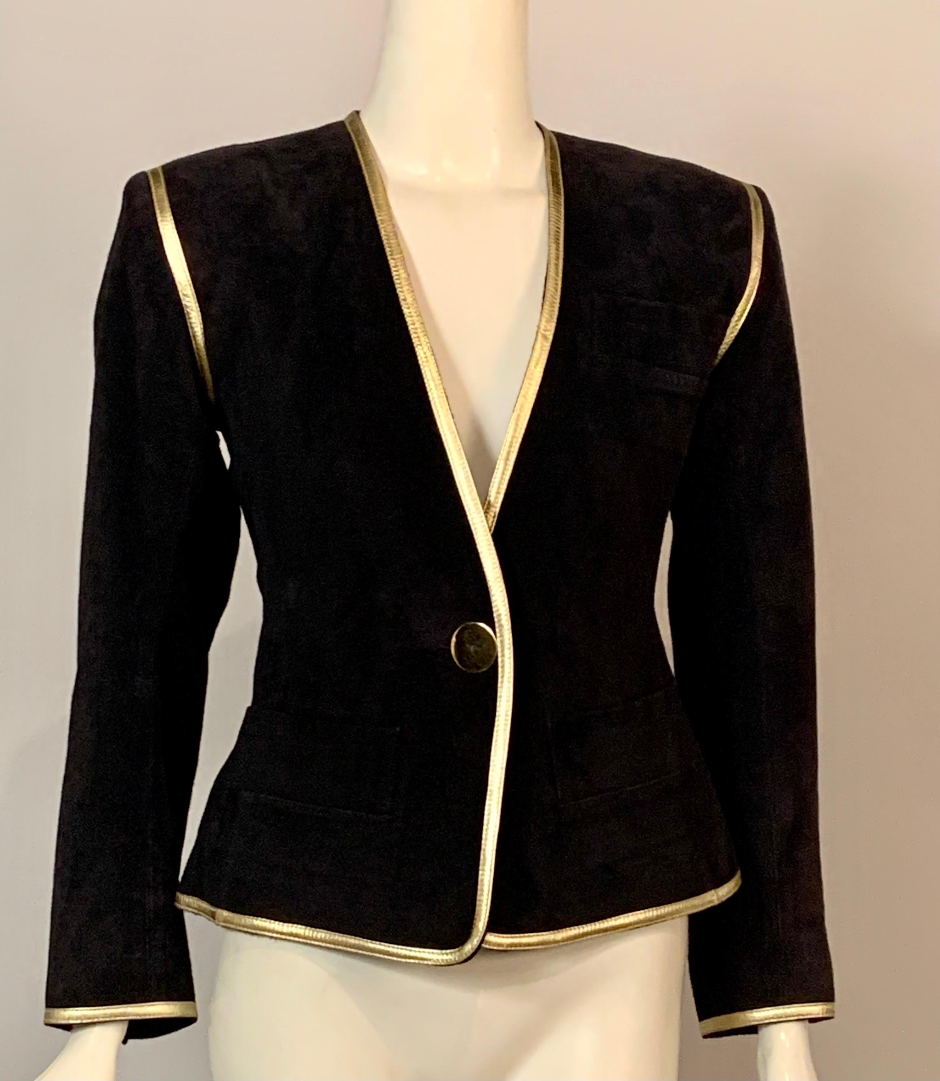 This Yves Saint Laurent jacket is so chic. A classic one button jacket in black suede is trimmed with gold leather and accented with a single brass button at the center front and on each cuff.   [Extra buttons are sewn inside]  It is lined in black