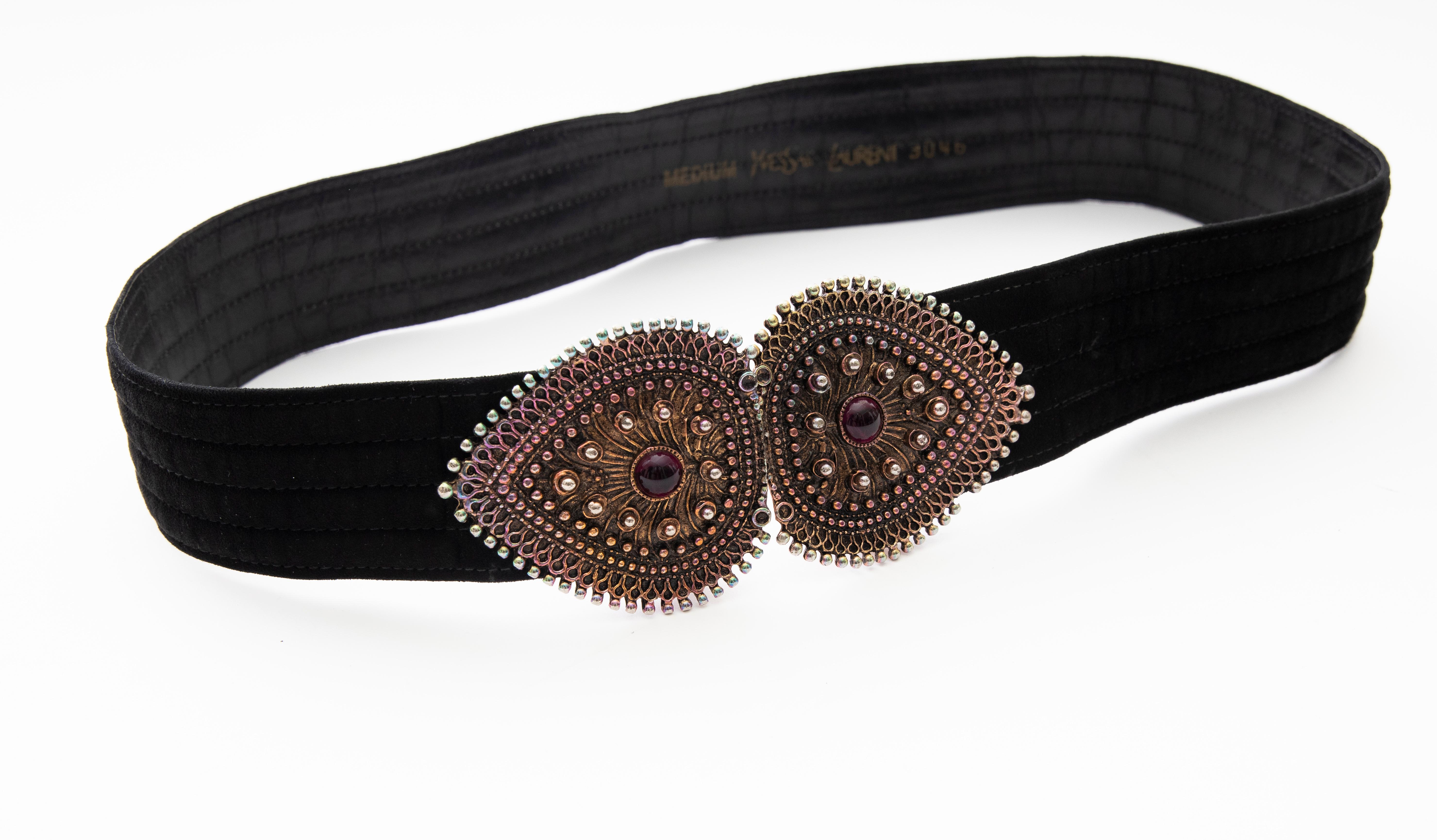 Yves Saint Laurent, late 1980's black velvet, metal, glass cabochons belt with hook closure.

Part of the Met Costume Institute Collection: Accession Number:2006.420.156

Length Max: 34, Width: 3.25
