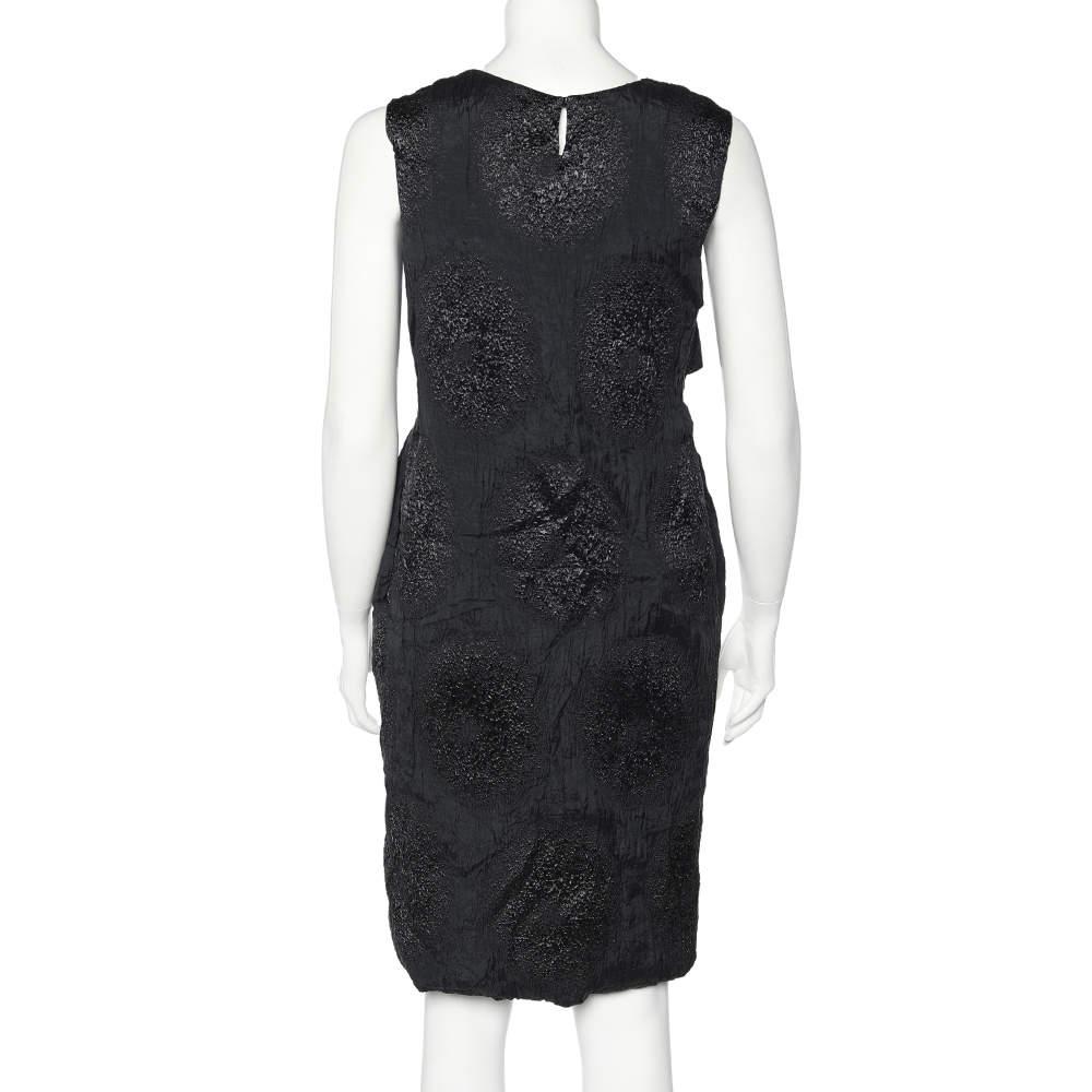 This mini dress from the House of Yves Saint Laurent will surely make you look stunning! It is tailored from textured silk fabric, which is highlighted with overlay detail. This sleeveless dress is provided with a zipper fastening.

