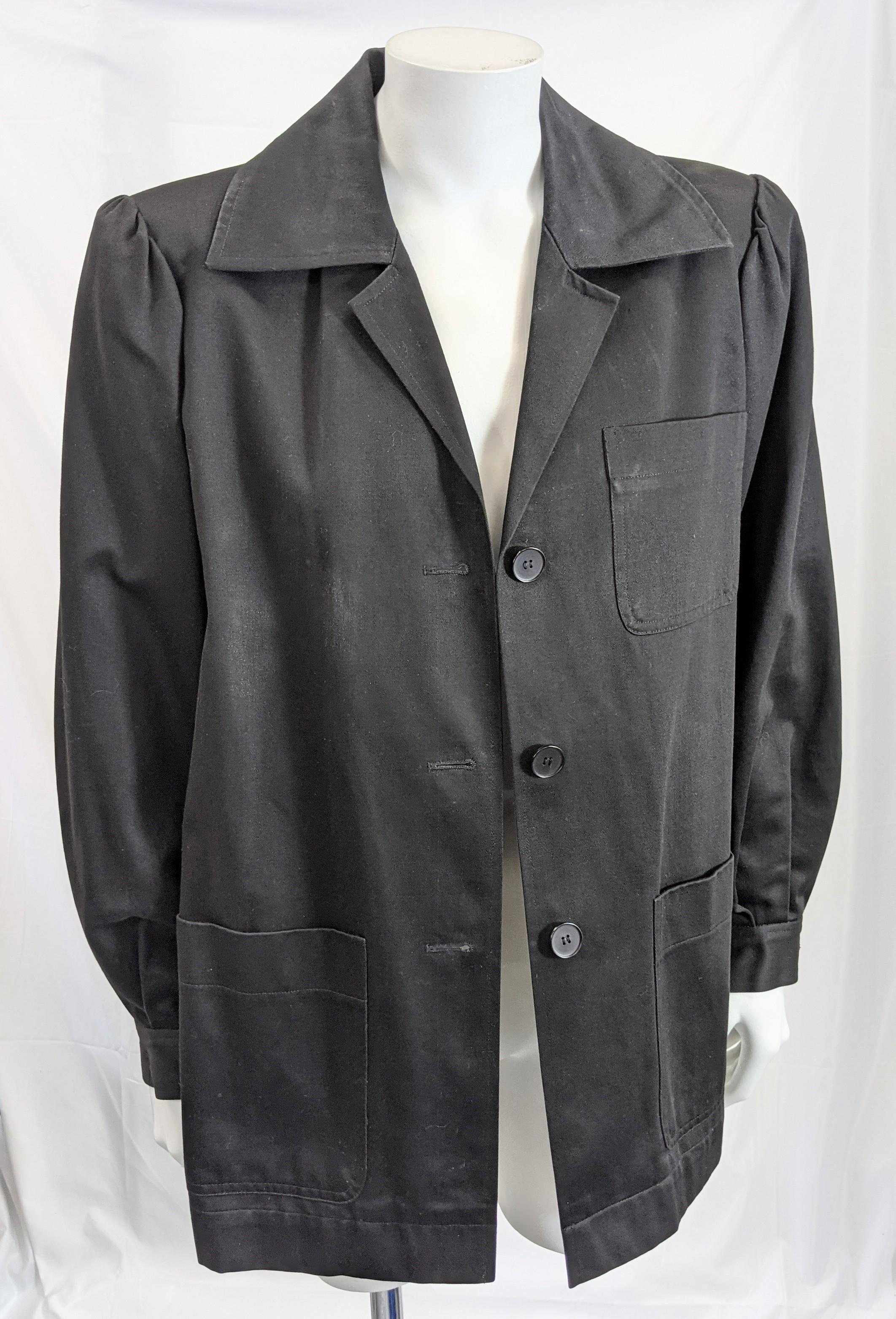 Early Yves Saint Laurent Black Cotton Twill Work Jacket from the 1970's. Patch pockets and gathered strong shoulder on YSL's take on this French work wear classic. 
Fully Lined. Size 34, France 1970's. Small size.