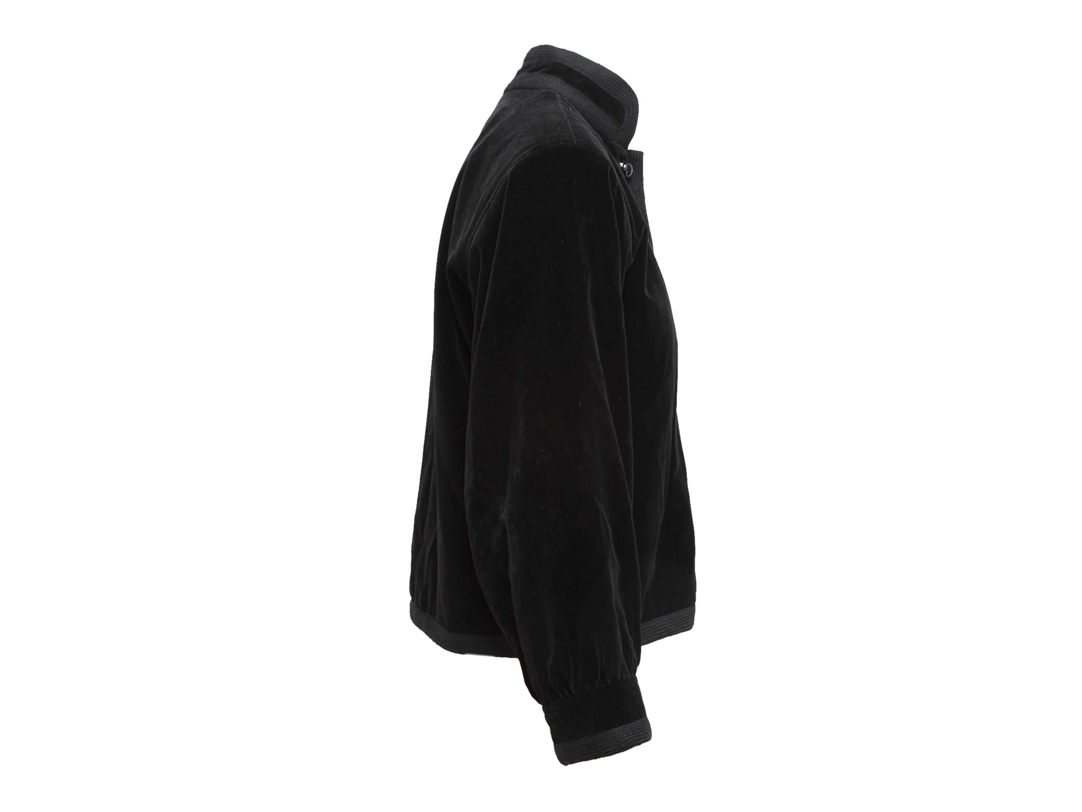 Product details: Vintage black velvet jacket by Yves Saint Laurent. Mandarin collar. Long sleeves. Knit trim throughout. Button closures at front. Designer size FR36. 40