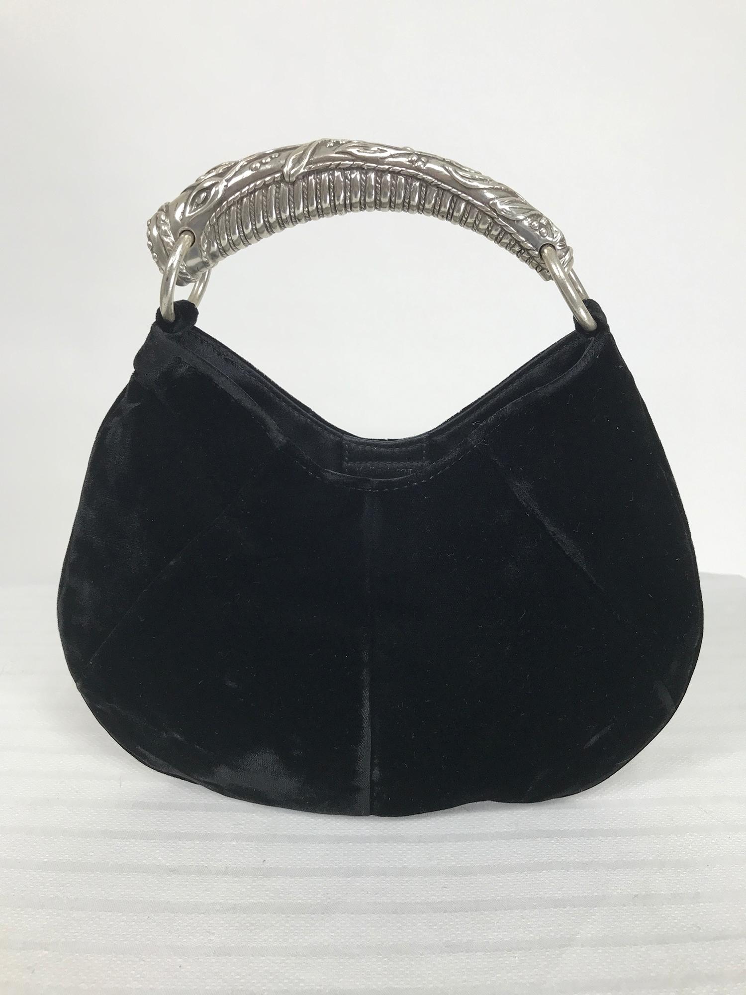 Yves Saint Laurent velvet mini Mombasa handbag designed by Tom Ford.  Repousse silver metal handle, the bag is black velvet, seamed to shape with a curved bottom. The bag is lined and there is an interior slip pocket. Closes at the inside top with a
