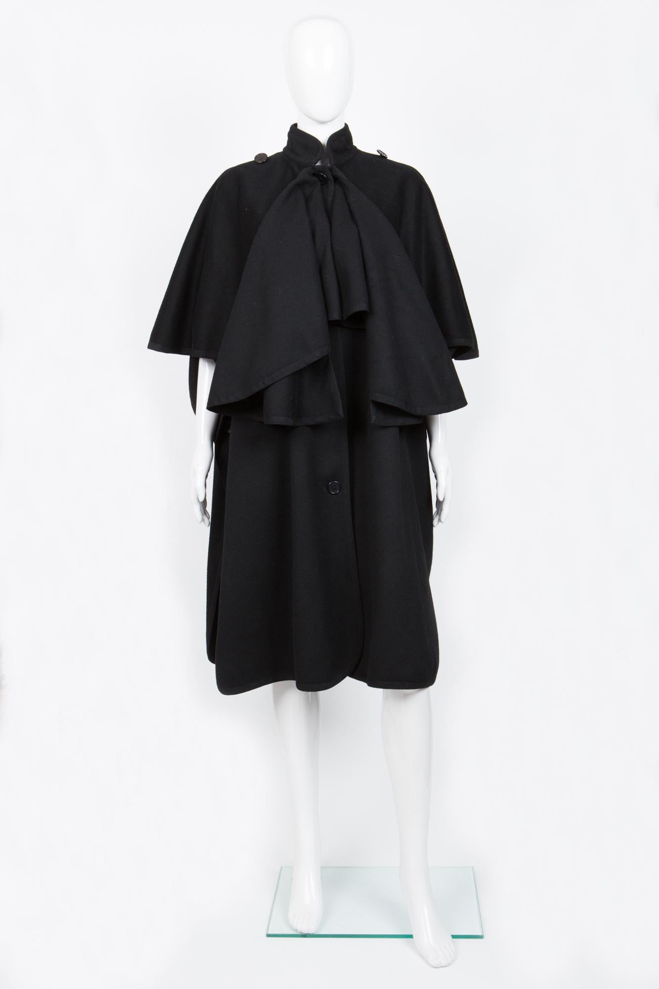 Saint Laurent black wool cape coat featuring a front button fastening, short sleeves, a braided edge and a mid-length. 100% wool
In excellent vintage condition. Made in France. 
Estimated size 38fr/US6 /UK10
We guarantee you will receive this