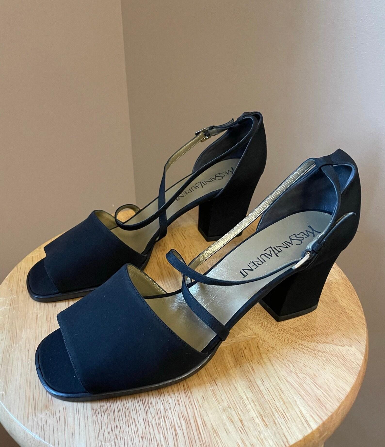 Vintage Yves Saint Laurent black open toe heels. Criss cross ankle straps. Chunky block heel.

○ Circa: 1990s
○ Label: Yves Saint Laurent
○ Material: Fabric Uppers (Feels like Silk), Leather
○ Color: Black
○ Excellent Condition! New Old Stock in