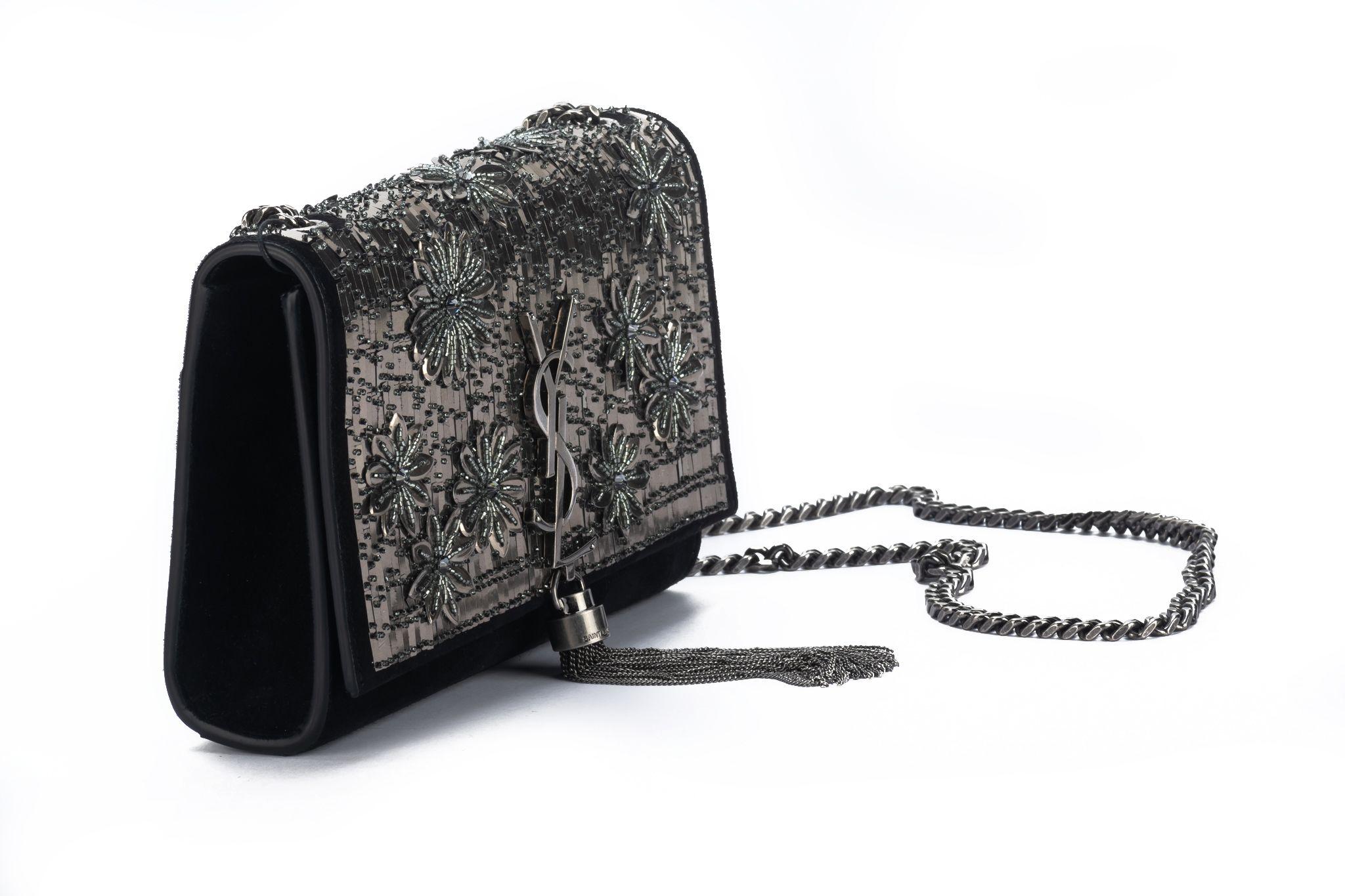 Yves Saint Laurent brand new beaded evening bag, black suede and gunmetal beading design. Can ne worn cross body or shoulder style .
Shoulder drop 22”. Comes with booklet and original dust cover .