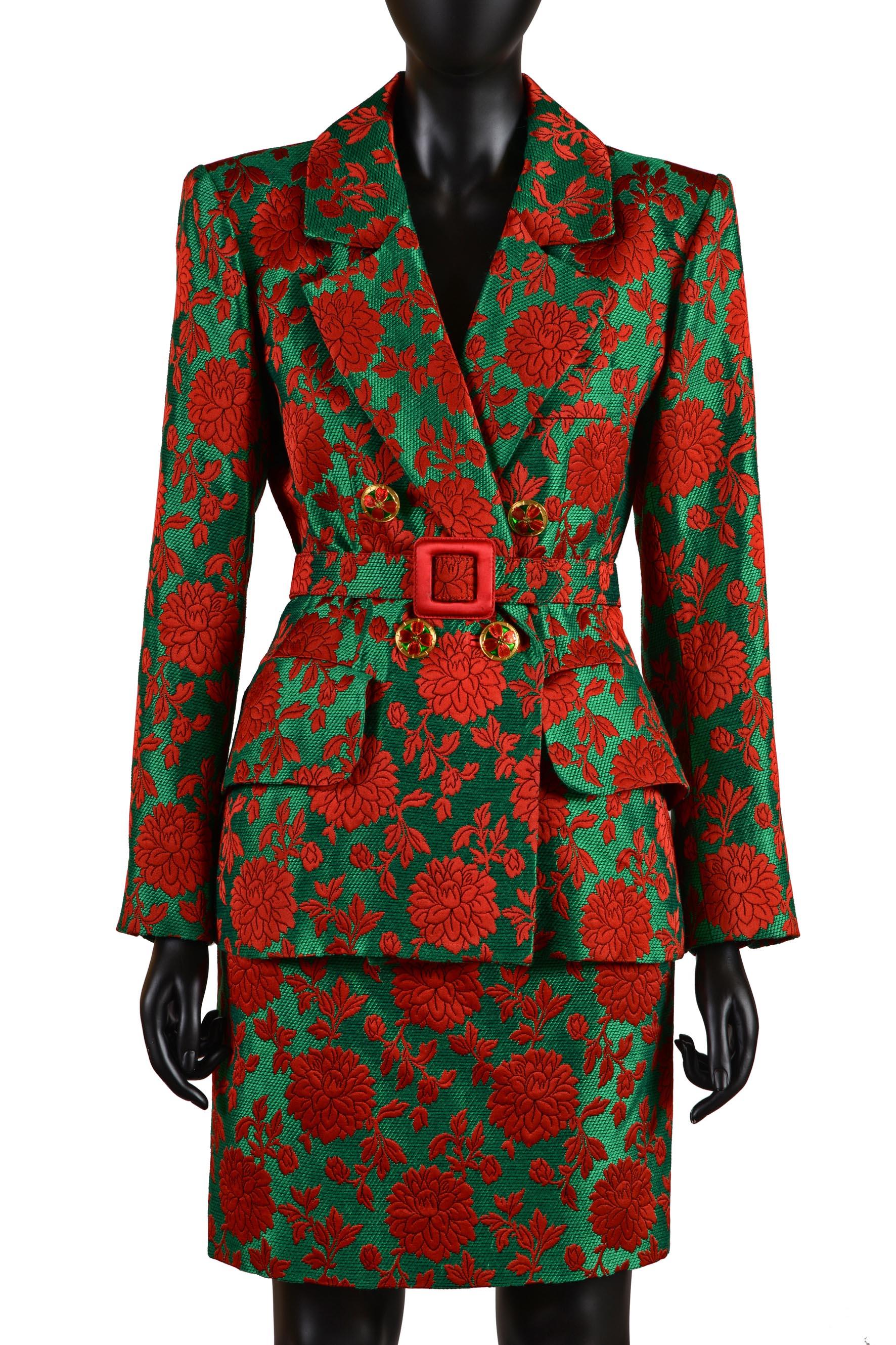 YVES SAINT LAURENT RIVE GAUCHE 
Autumn Winter 1992 Collection
Green and red brocade suit
Guilloched enamel buttons
Belt in the same fabric with red fabric buckle
Size 36 FR.
Made in France.
Fabric: 100% acetate
Lining: 55% acetate - 45% cupro

Flat