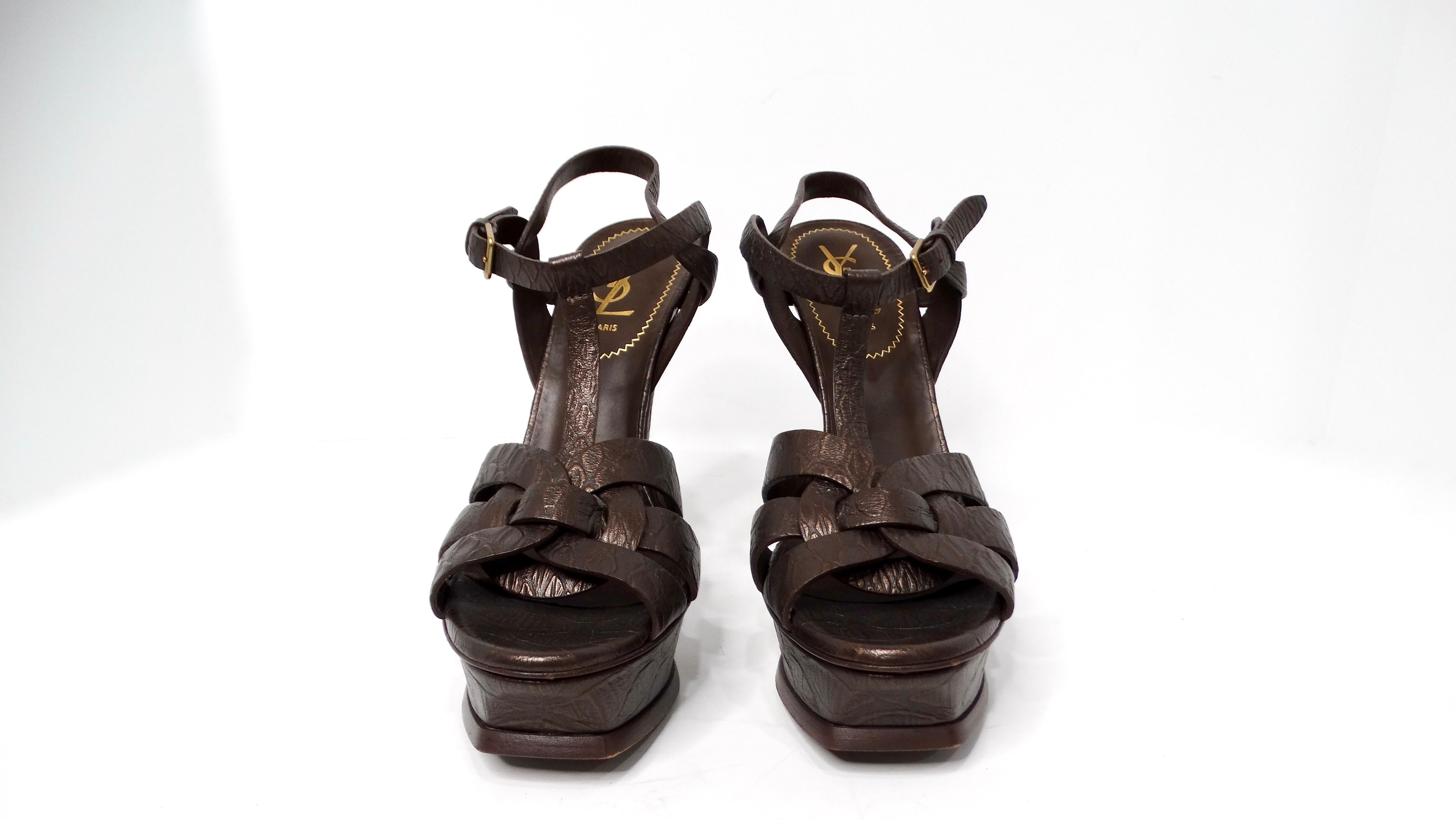 The Yves Saint Laurent Bronze Tribute Croc Embossed Platform Leather High Heels are the epitome of luxury and sophistication. Crafted from sumptuous leather, these stunning heels feature a unique croc-embossed texture that adds a touch of exotic