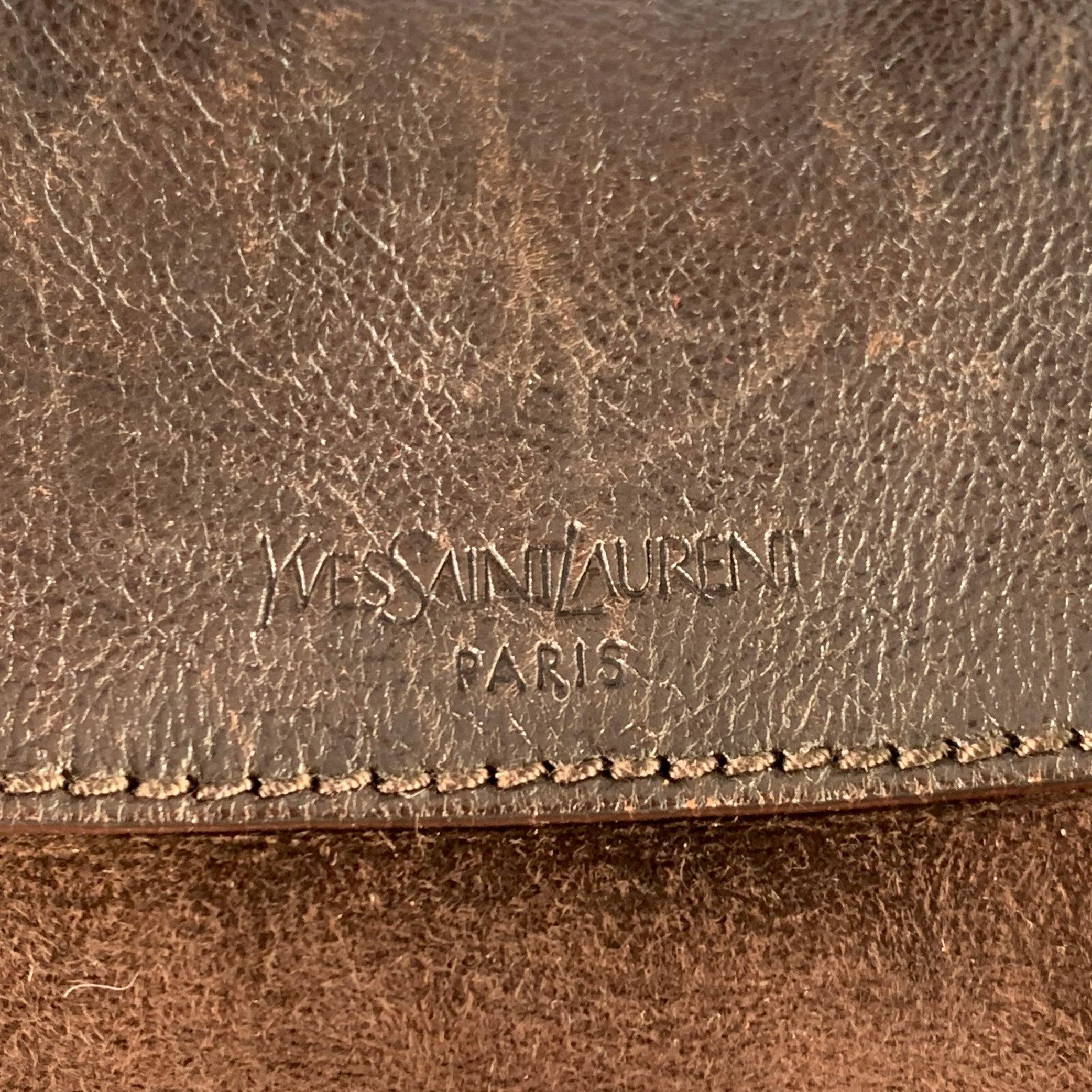 YVES SAINT LAURENT shoulder handbag
in a brown leather with shearling lining featuring gold tone metal hardware, two side pockets with buckle closure, and magnet closure. Made in Italy.Very Good Pre-Owned Condition. Multiple minor marks. 

Marked:  