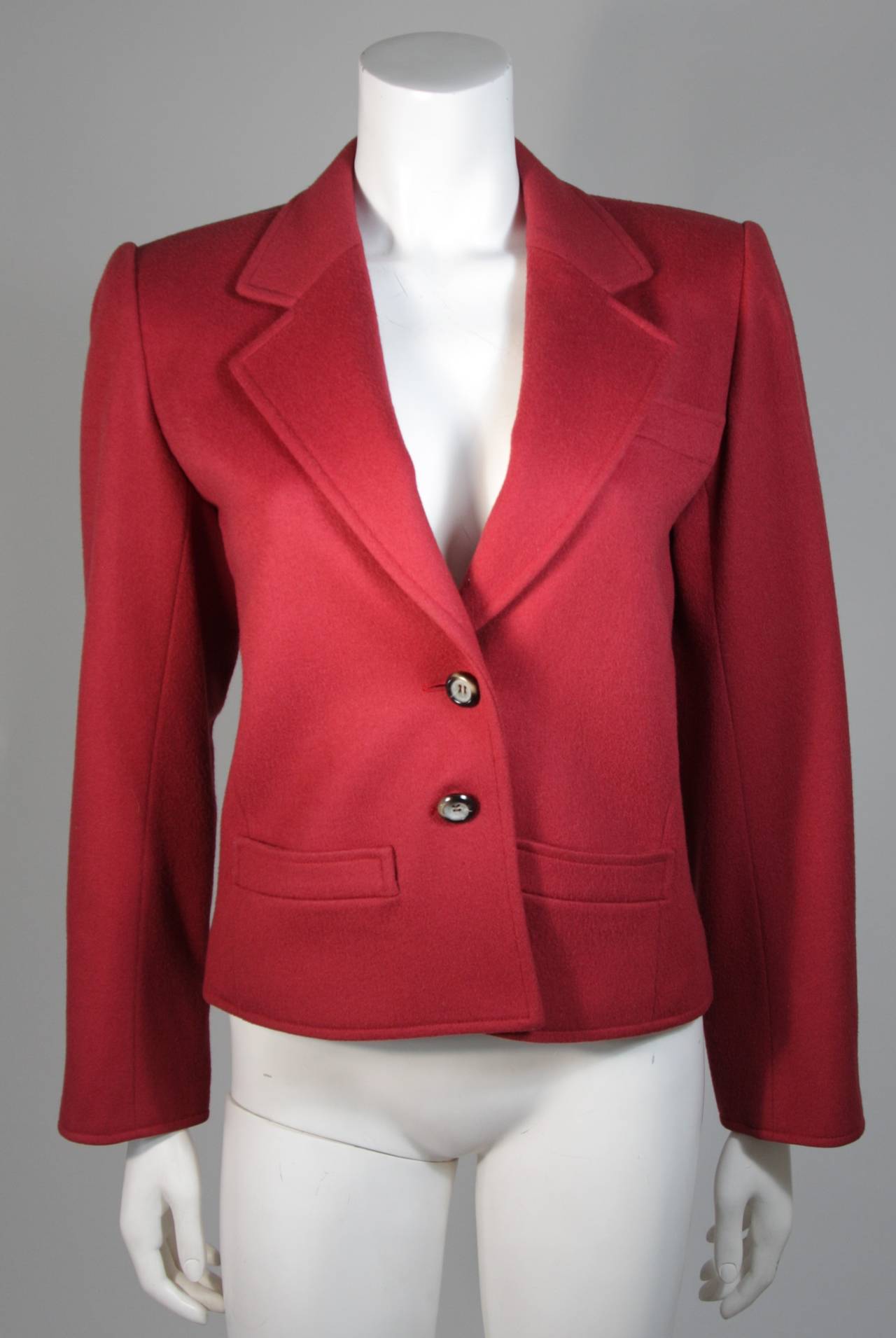 This Yves Saint Laurent jacket is composed of a burgundy wool. Featuring notch collar with two front pockets. In excellent condition. Made in France.

**Please cross-reference measurements for personal accuracy. The size listed in the description