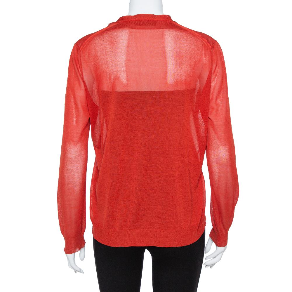 Yves Saint Laurent delights us with this wonderful cardigan. It is knit from a smooth cotton and silk blend and styled in a red hue with front buttons and long sleeves. The cardigan will be a luxurious addition to your closet.

