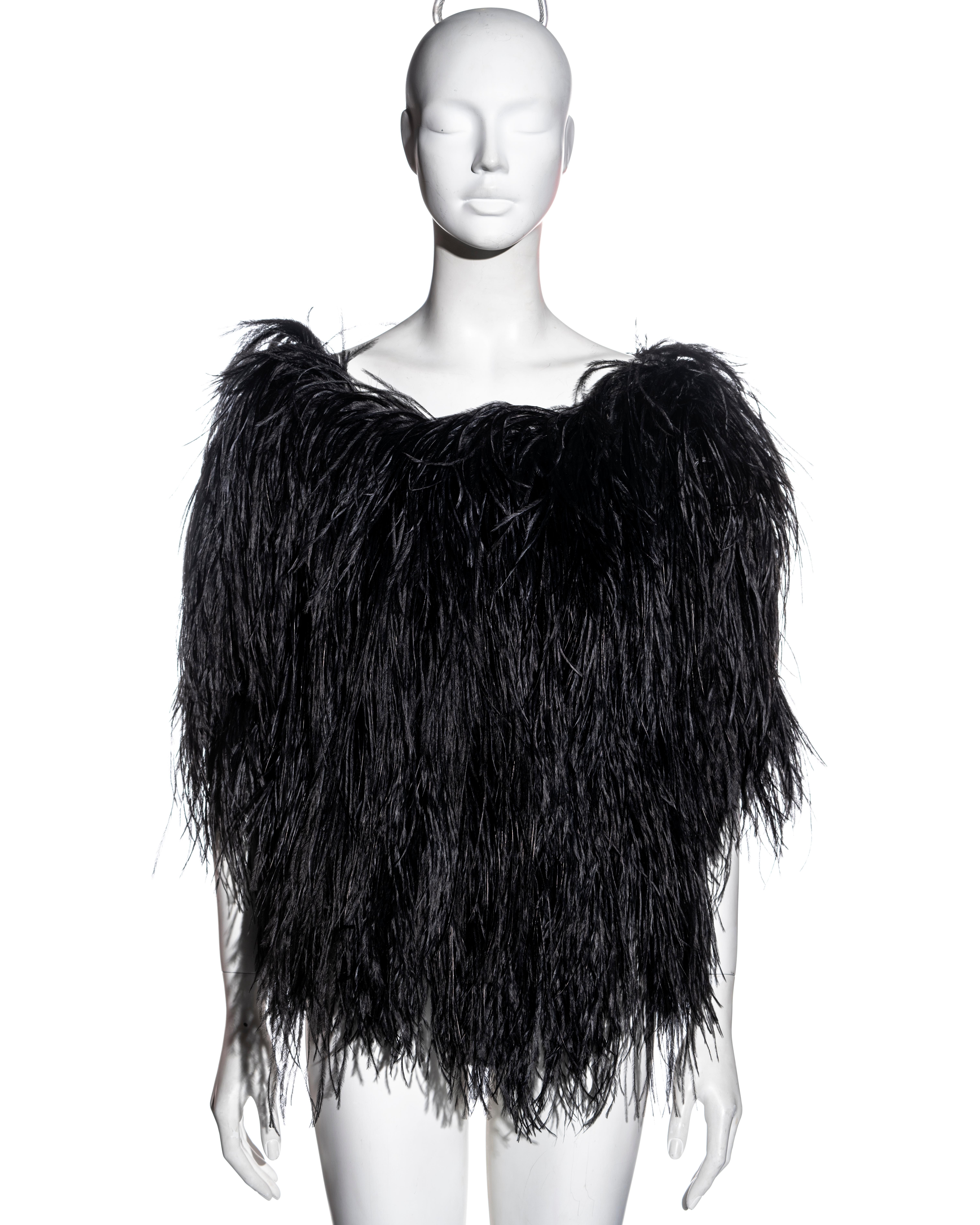 ▪ Yves Saint Laurent black ostrich feather top
▪ Designed by Alber Elbaz
▪ Wide neckline 
▪ Short sleeves
▪ Silk organza lining 
▪ Hidden snap button fastenings at the side seam
▪ Size: Small - Medium
▪ Fall-Winter 1999
▪ 100% Silk
▪ Made in France
