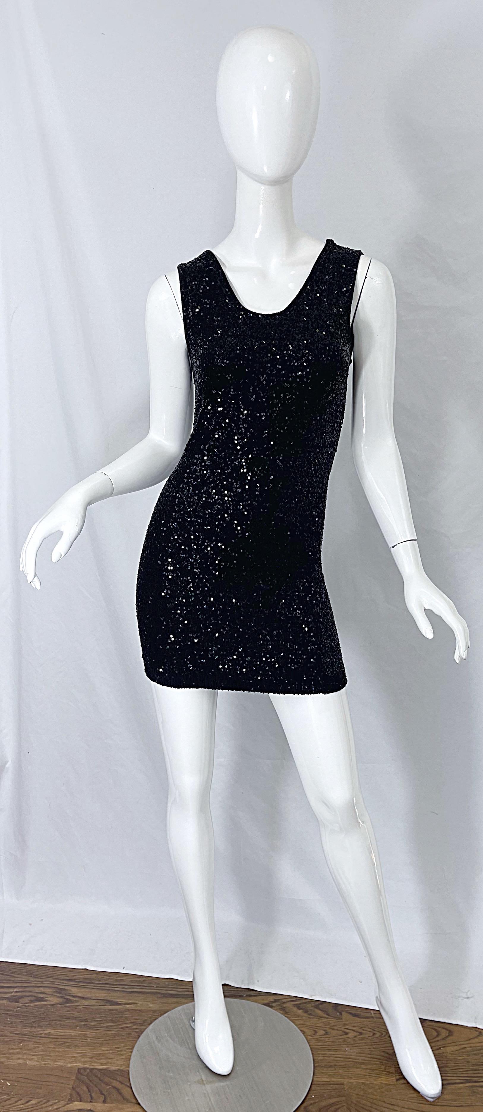 Sexy YVES SAINT LAURENT 2008 black sequin mini sweater dress ! Features thousands of hand-sewn black sequins over the entire dress. Simply slips over the head. Plunging back reveals just the right amount of skin. 
Great with heels or boots
In great