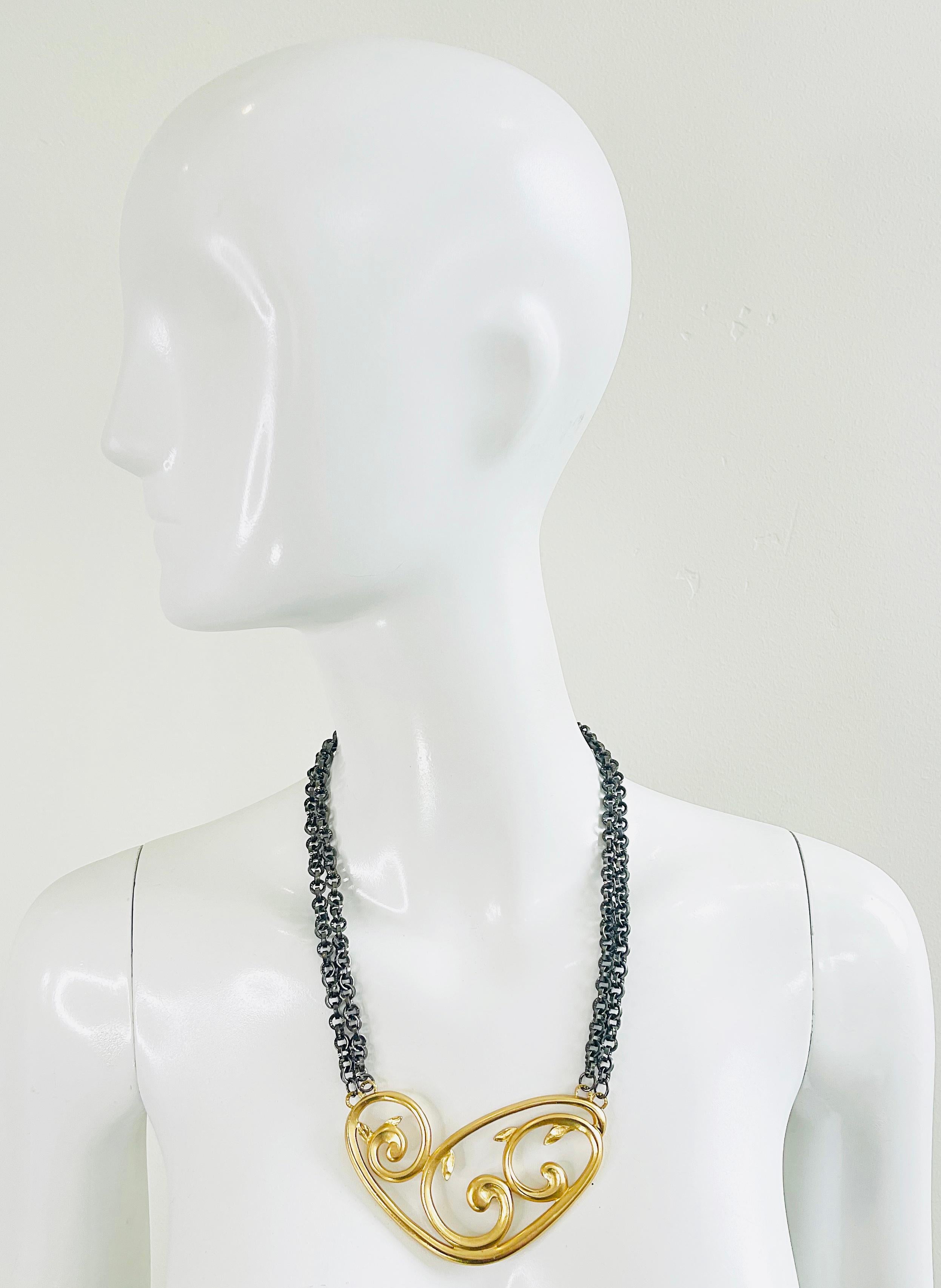 Limited Edition 80s vintage YVES SAINT LAURENT by ROBERT GOOSSENS gilded vermeil gold and gunmetal scroll necklace. This YSL beauty is numbered 105/500, meaning that only 500 were produced. Two gunmetal silver chains with clasp closure. 
Can easily