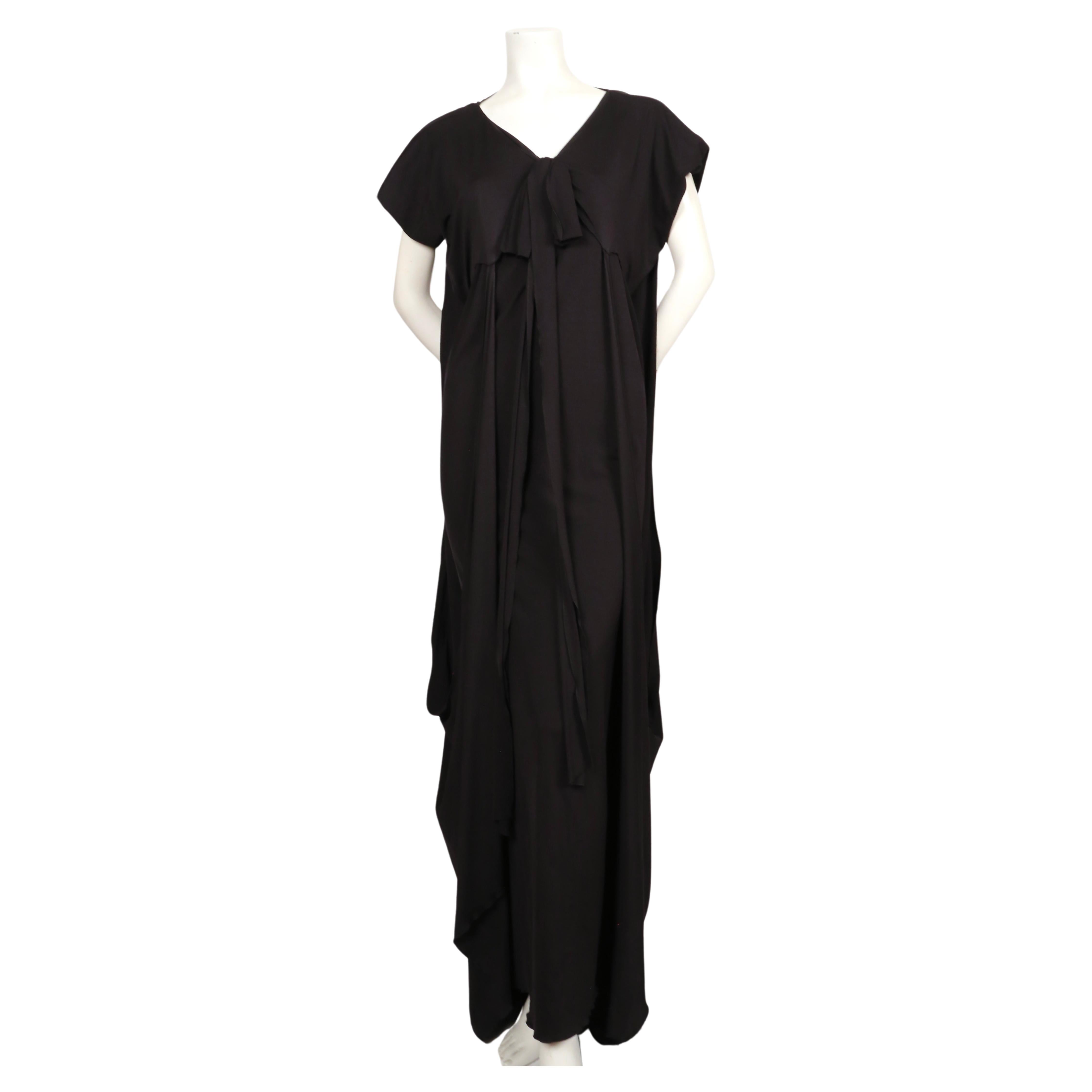 Dramatic, jet black caftan dress with draped sides at designed by Stefano Pilati for Yves Saint Laurent dating to spring of 2009' Labeled a French size XXS although this dress is very stretchy 40. Dress measures approximately: 34
