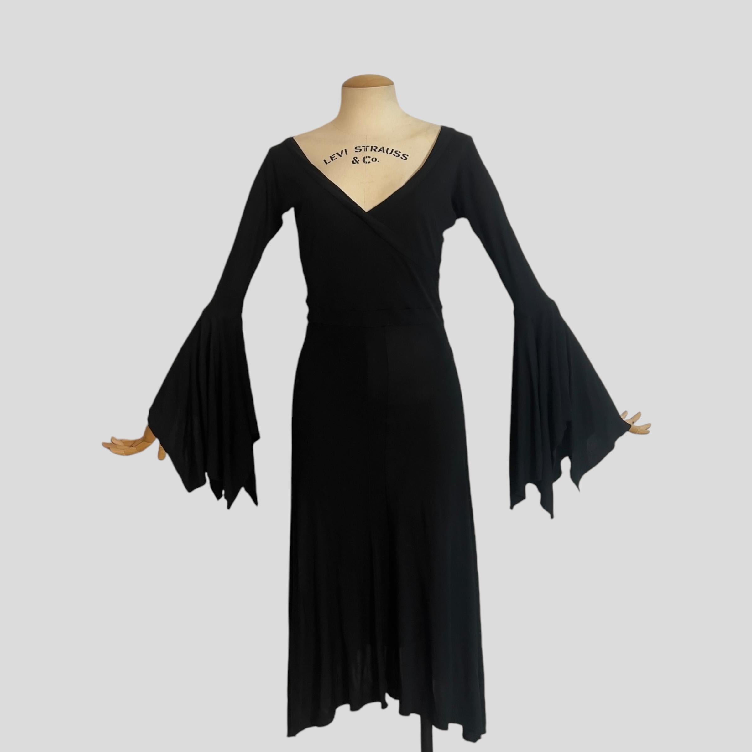 Piece Description: This stunning black wrap dress from Yves Saint Laurent’s Spring/Summer 2003 collection, designed by Tom Ford, is an exquisite example of his sultry, feminine vision for the house. Debuting as Look 28 on the runway, worn by Ujjwala