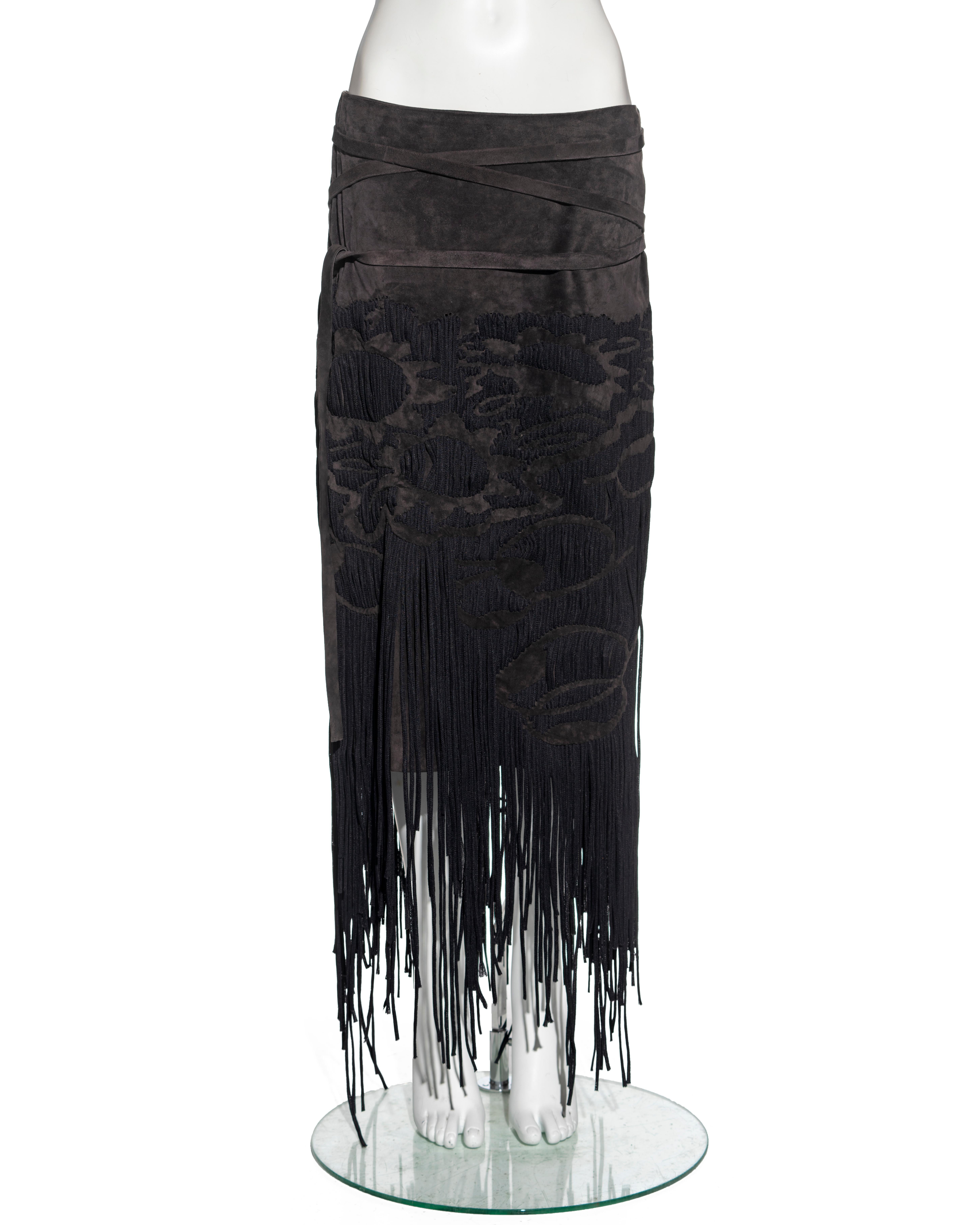 ▪ Yves Saint Laurent runway skirt
▪ Designed by Tom Ford 
▪ Sold by One of a Kind Archive
▪ Constructed from dark brown suede 
▪ Abstract pattern made up with a multitude of woven laces  
▪ Long fringe trim 
▪ Attached belt  
▪ Silk lining 
▪