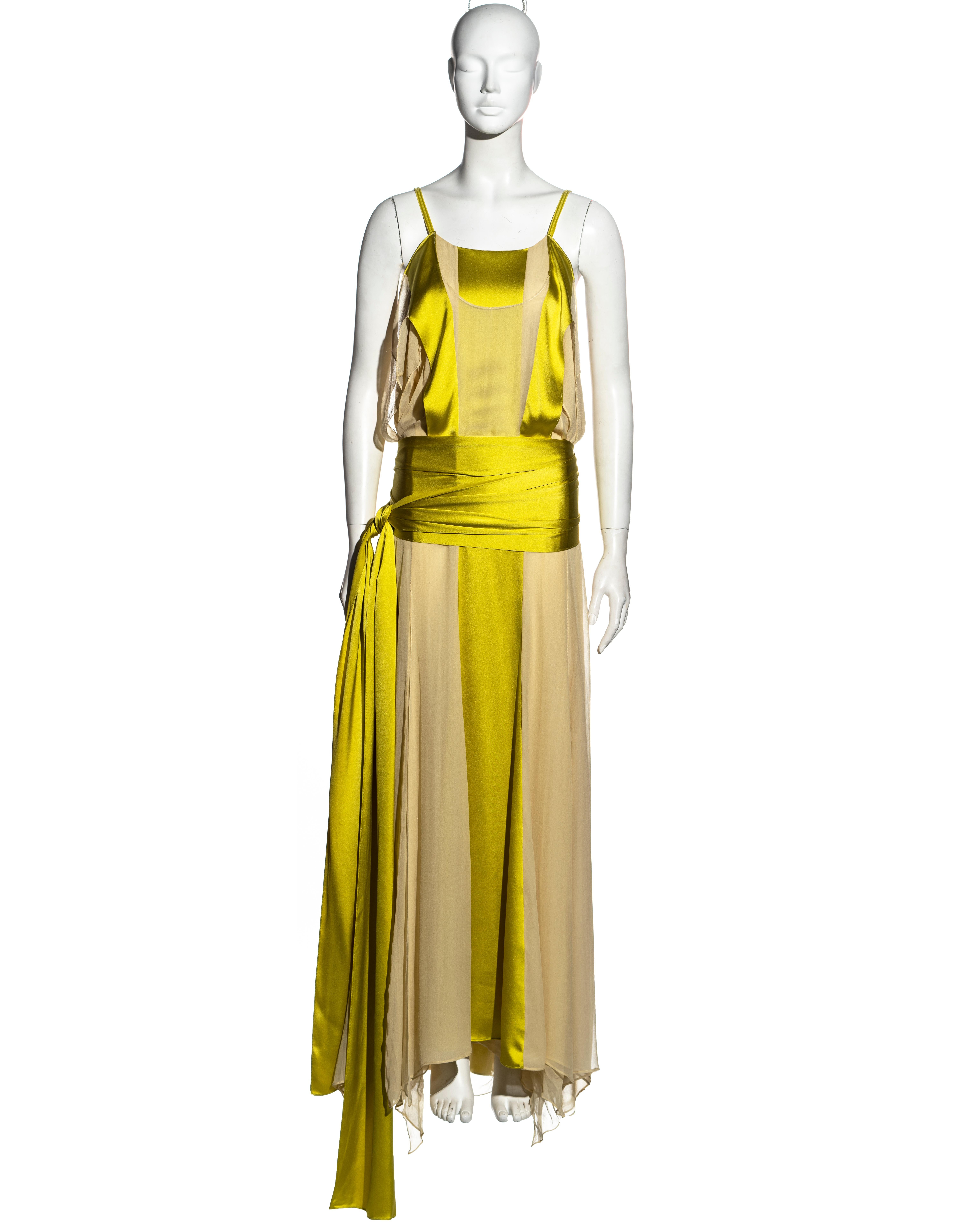 ▪ Yves Saint Laurent chartreuse silk evening dress
▪ Designed by Tom Ford 
▪ Vertical panels of cream chiffon and chartreuse silk 
▪ Two long ties fastening around the hips 
▪ Draped panels at the side body 
▪ Velvet spaghetti straps 
▪ Silk button