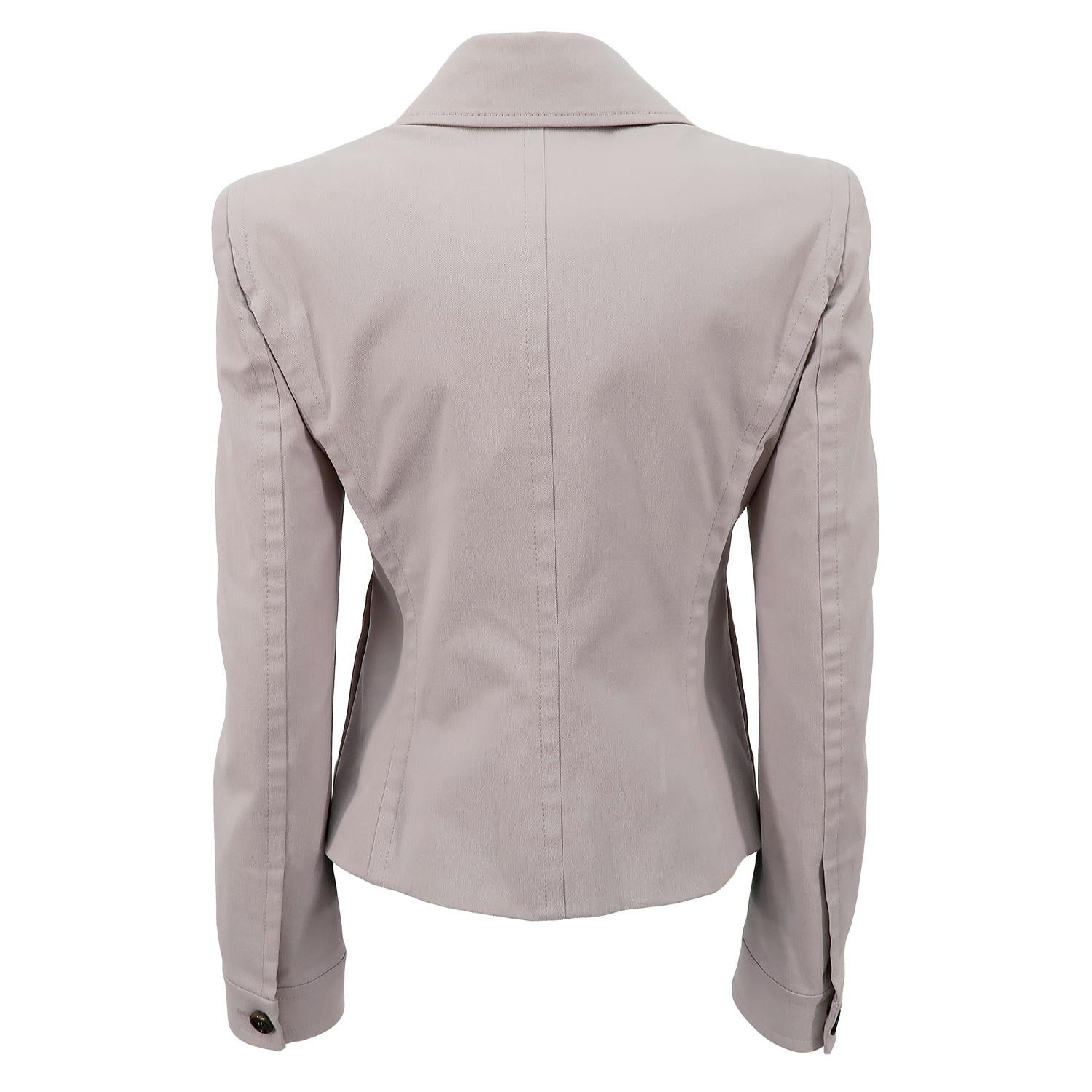 Balancing the sleek with the frivolous was a leitmotiv for Tom Ford during his years at the House of Yves Saint Laurent. Here, he pairs the streamlined shape of a classic blazer with the extravagance of statement ruffles. This striking jacket can