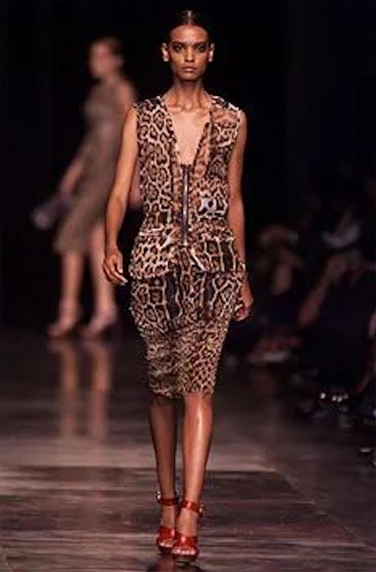 This leopard print two piece was the opening look for Yves Saint Laurent’s Spring Summer 2002 Rive Gauche collection by Tom Ford.

This elegant two-piece consists of a high waisted silk pencil skirt and a zip up sleeveless silk top in a classic
