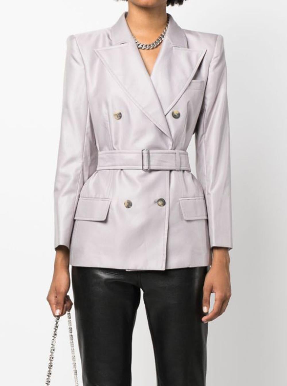 YSL Yves Saint Laurent by Tom Ford lilac cotton belted double-breasted blazer featuring peak lapels, double-breasted button fastening, long sleeves, buttoned cuffs, pocket at the chest, detachable waist belt, two front flap pockets.
Composition: