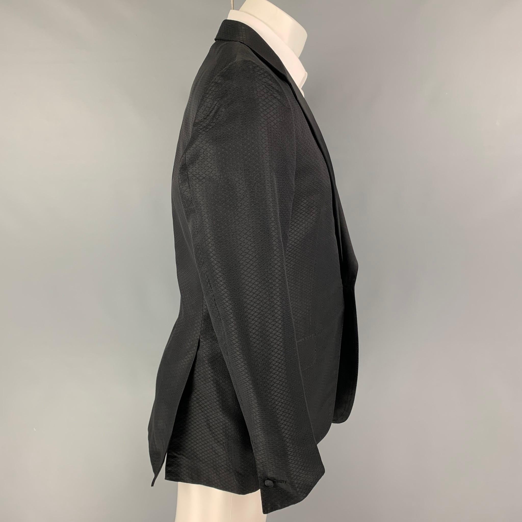 YVES SAINT LAURENT by Tom Ford sport coat comes in a black textured / silk featuring a notch lapel, flap pockets, double back vent, and a single button closure. Made in Italy. 

Very Good Pre-Owned Condition.
Marked: 50

Measurements:

Shoulder: 17