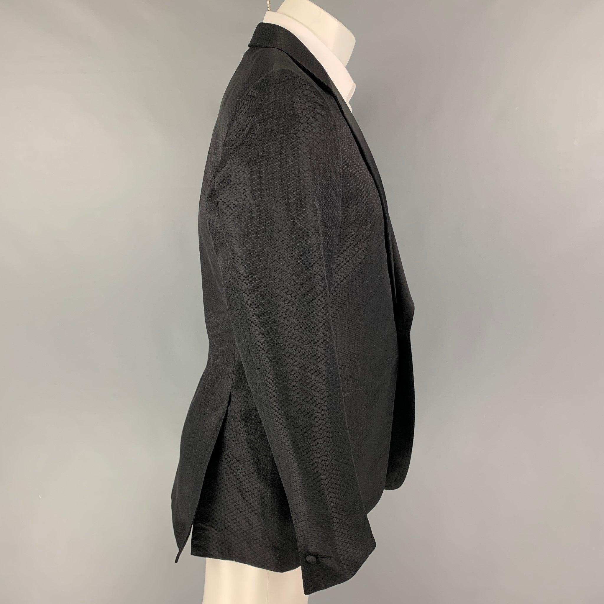 YVES SAINT LAURENT by Tom Ford sport coat comes in a black textured / silk featuring a notch lapel, flap pockets, double back vent, and a single button closure. Made in Italy.
Very Good
Pre-Owned Condition.  

Marked:   50 

Measurements: 
