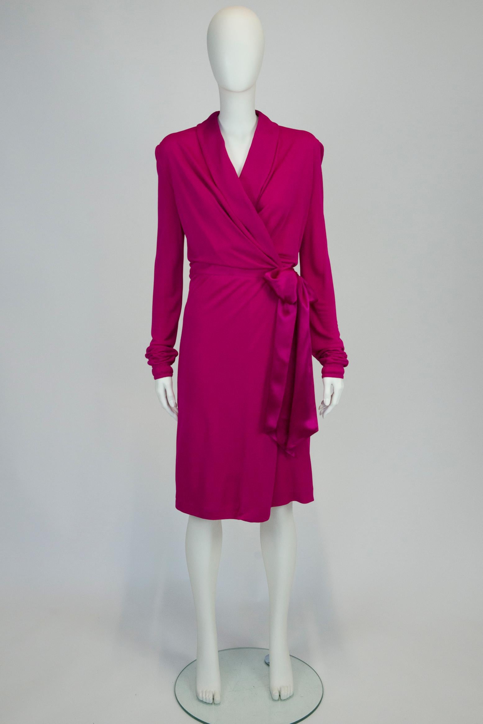 Effortlessly chic, this early 2000 Yves Saint Laurent by Tom Ford wrap dress will deliver glamour and sophistication for any occasion. Cut from comfortable vibrant fuchsia crepe-viscose, it has a plunging V-neckline and satin-silk waist sash ties to