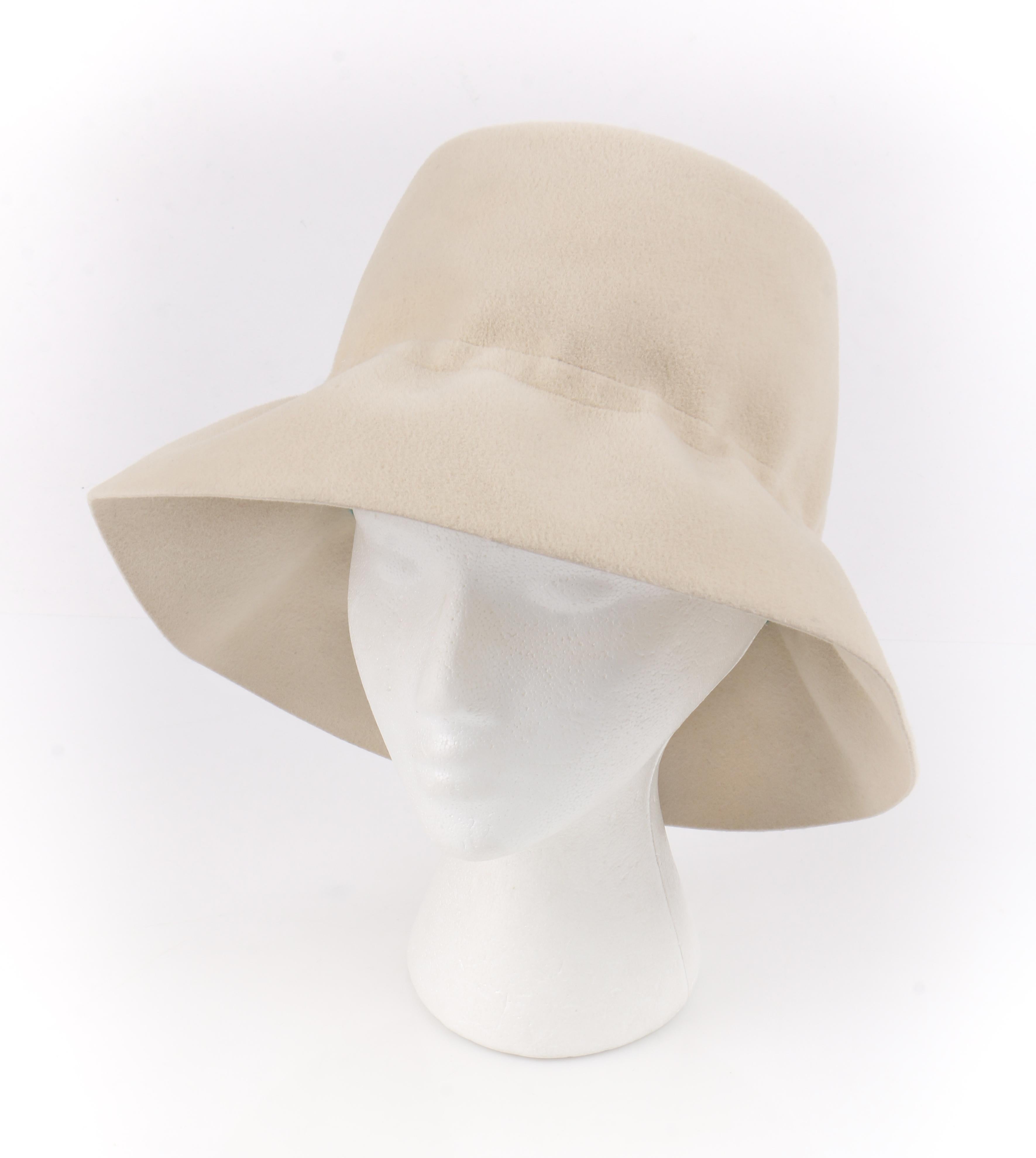YVES SAINT LAURENT c.1960’s YSL Cream Felted Fur Structured Bucket Hat
 
Circa: 1960’s
Label(s): Yves Saint Laurent / Paris - New York / Luxuria Imported Body Made In Italy
Style: Bucket Hat
Color(s): Cream and brown
Lined: No 
Unmarked Fabric
