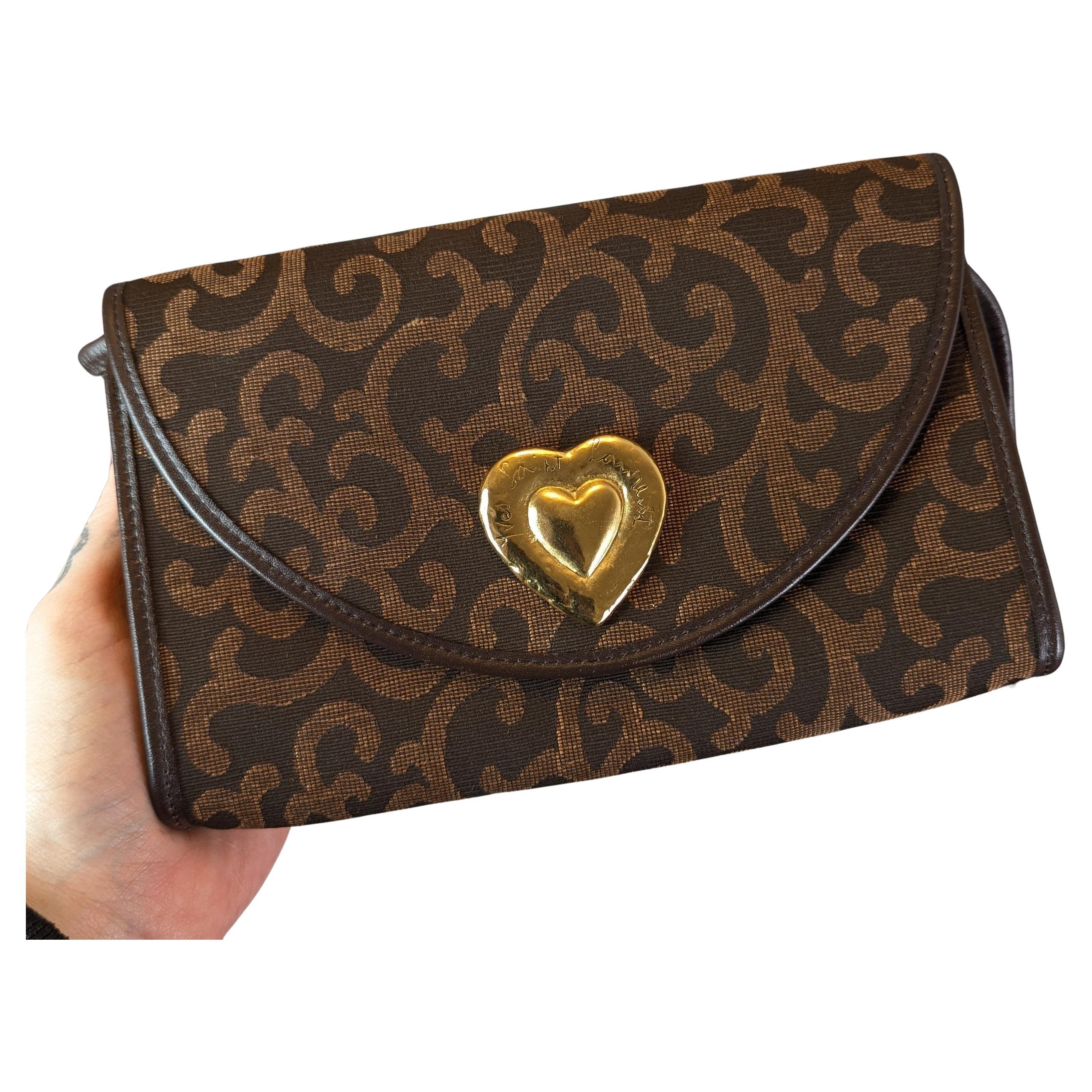 Bolso bandolera de lona Yves Saint Laurent, corazón dorado en venta