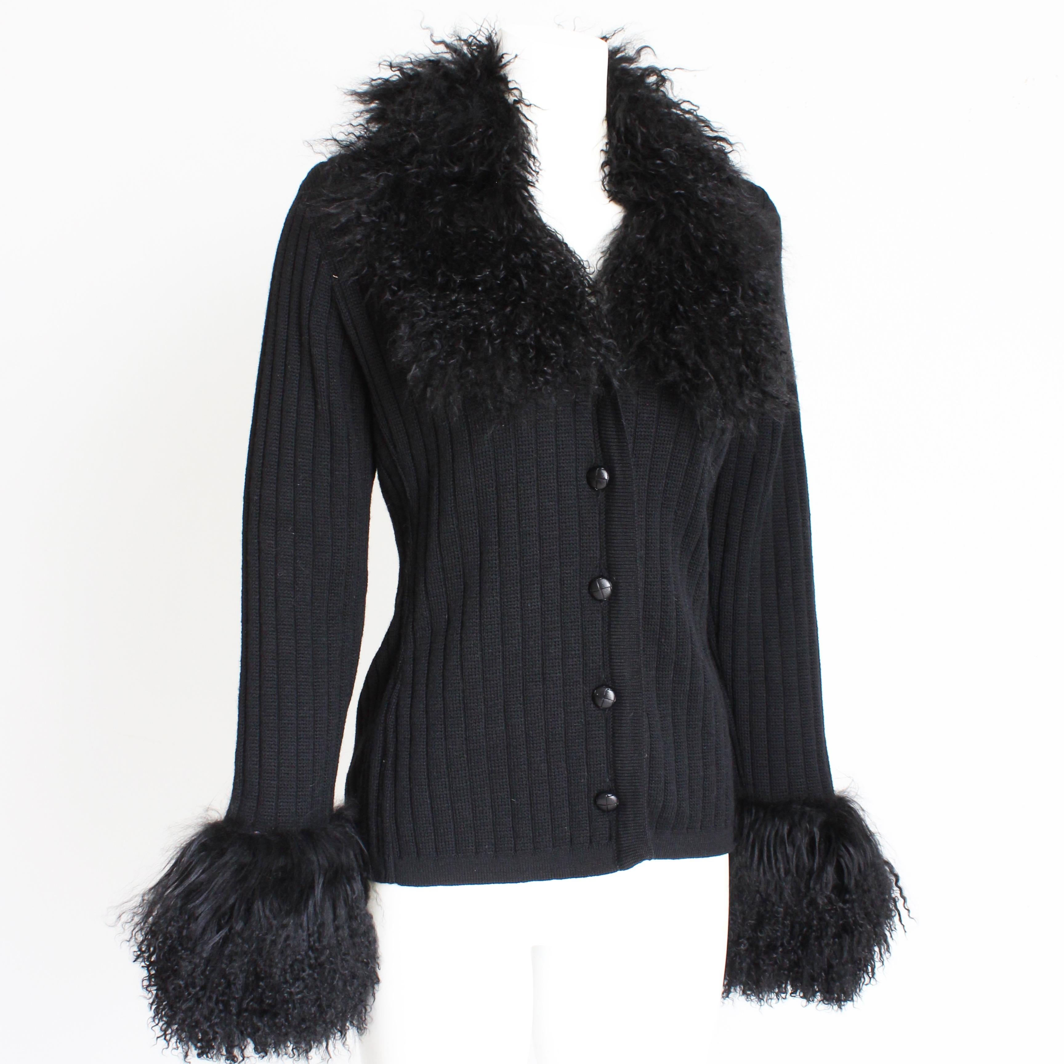 Fabulously chic black cardigan, designed by Yves Saint Laurent, most likely in the late 70s.  Made from a black wool knit, it fastens with decorative buttons and features chic black Mongolian lamb fur at the collar and sleeve bottoms.

Jackie