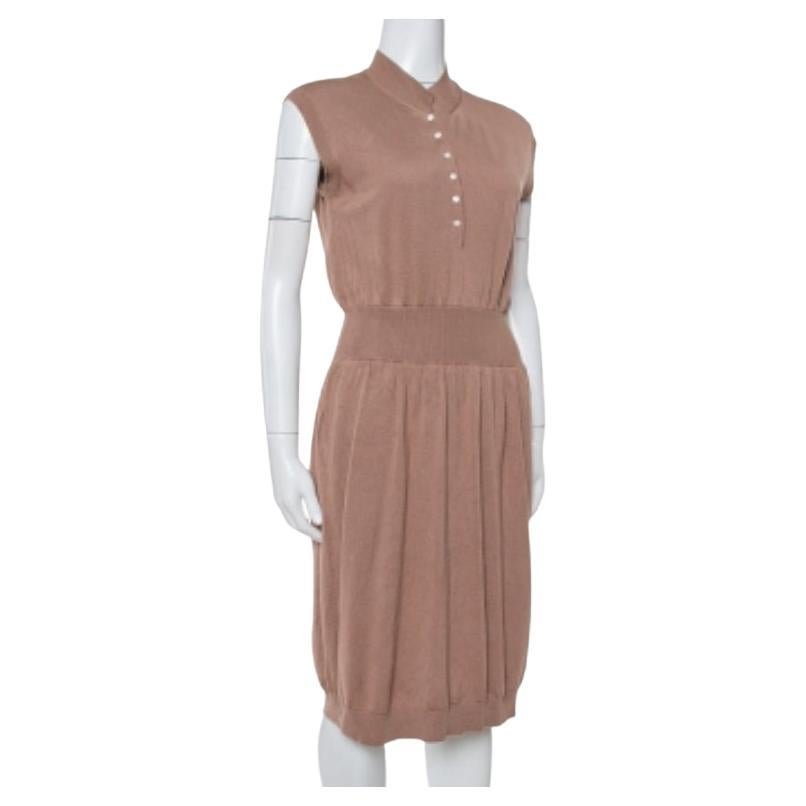 This timeless dress from the house of Saint Laurent Paris is a wardrobe staple. Simple yet stylish, this brown sleeveless creation will take your style quotient to new heights. It features a wool knit design with button fastenings on the bodice, a