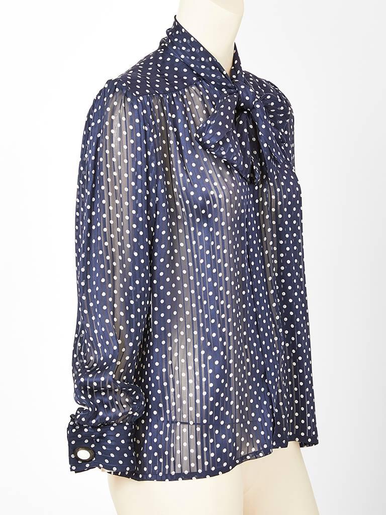 Yves Saint Laurent, Rive Gauche, navy chiffon, polka dot Lavaliere blouse having a yoke at the shoulders  and back with soft gathering and a tie at the neck.