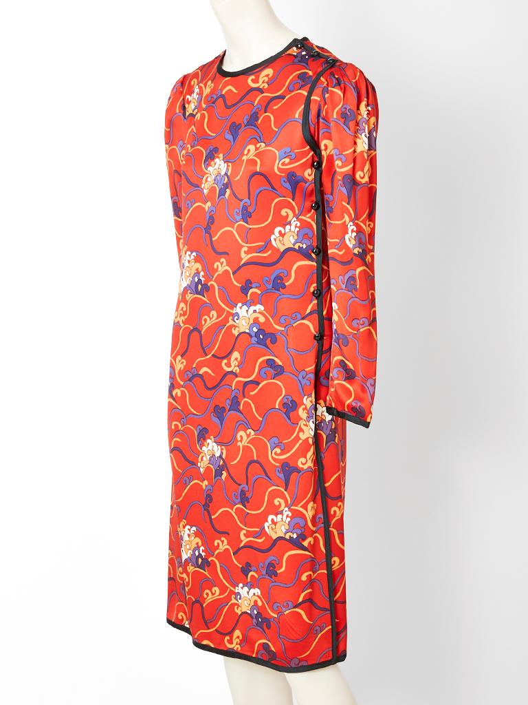 Yves Saint Laurent, Rive Gauche, multi tone,  patterned, chinese collection dress having a terra cotta tone background with a wave-like floral pattern. Dress has a contrasting, purple, braided trim at the neckline, shoulder seams, cuff , side seams