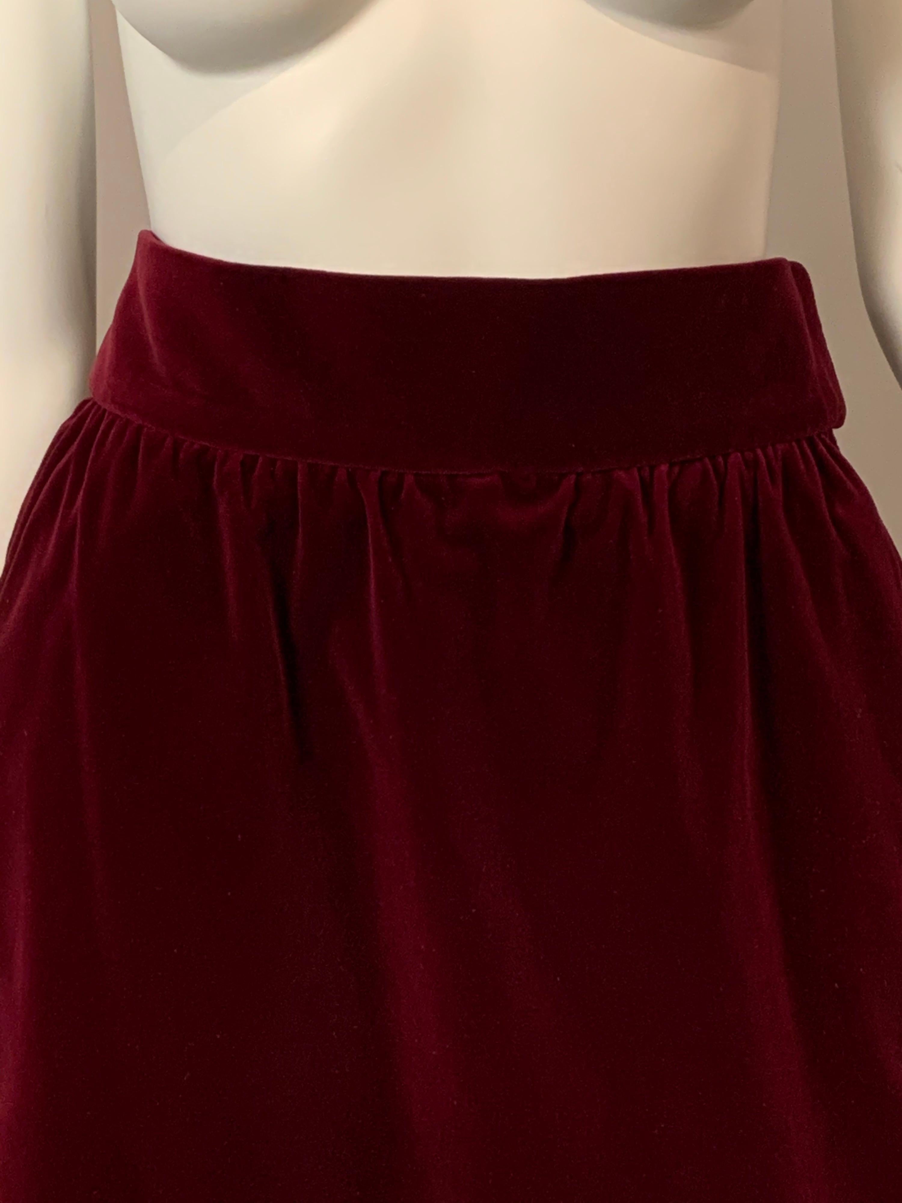 Yves Saint Laurent chose a beautiful and rich claret colored velvet for this straight skirt with a slightly gathered waist, two side pockets, a left side zipper and a high waistband.  It is fully lined, marked a size 42 and is in excellent