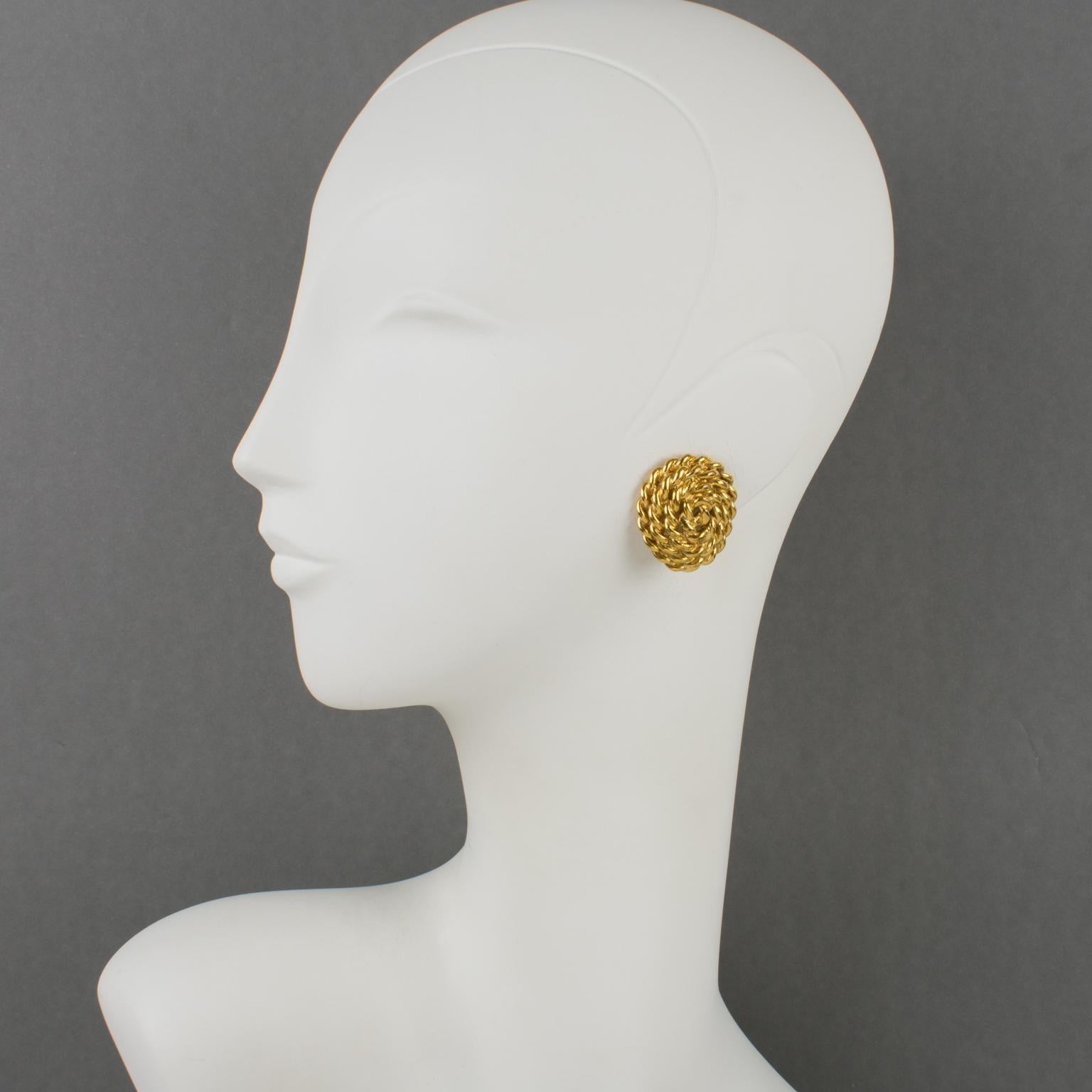 Yves Saint Laurent Paris designed those elegant stud clip-on earrings. The dimensional ovoid shape has gilt metal, all textured and carved in a rope design. The pieces are signed at the back with YSL pierced logo on the fastenings and, also engraved
