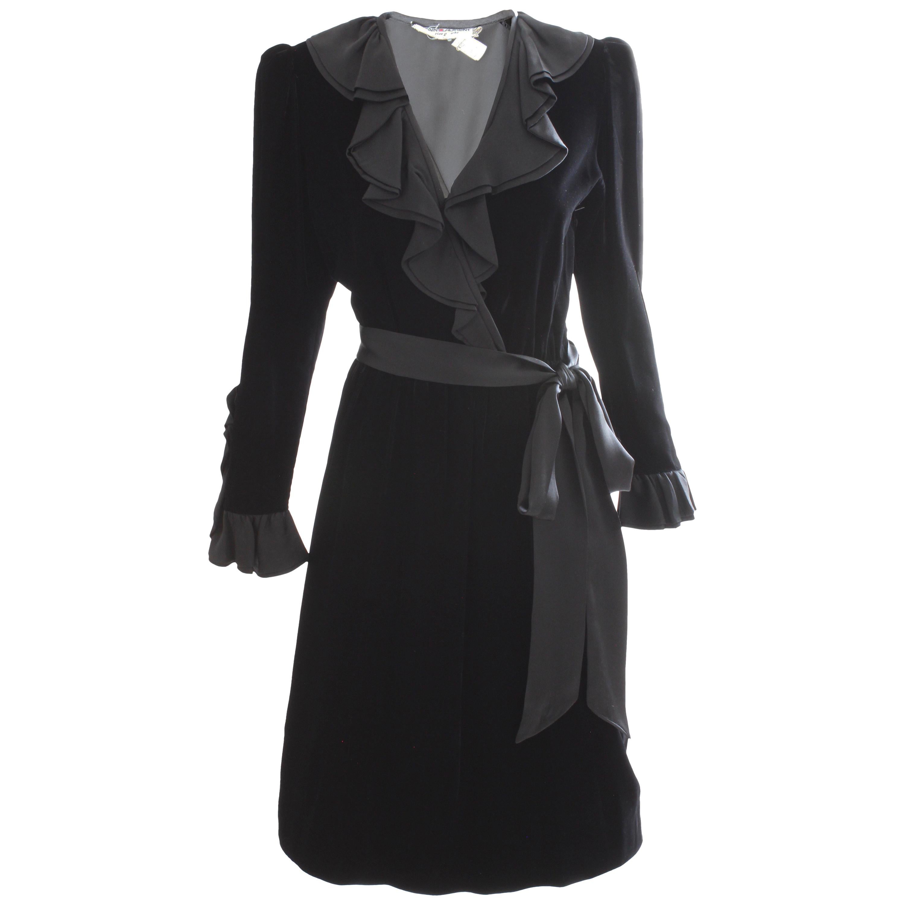 This incredible cocktail dress was made by Yves Saint Laurent, most likely in the 1970s. Made from silk velvet, this dress features black satin ruffle detailing at the collar and neckline, and on the back of each sleeve. Comes with its original