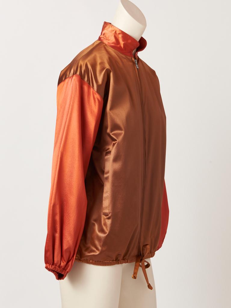Yves Saint Laurent, Rive Gauche, color block, satin bomber jacket, having a mandarin collar, with a metal zipper closure down the center front, slash pockets at the sides and a drawstring closure at the hip  creating a blouson affect. Body of the