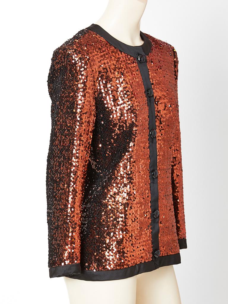 Yves Saint Laurent, fitted cardigan embellished with copper sequins.  Jacket has a rounded neckline, with black satin trimming at the neck, center front, hem and wrists. Center front button closure.