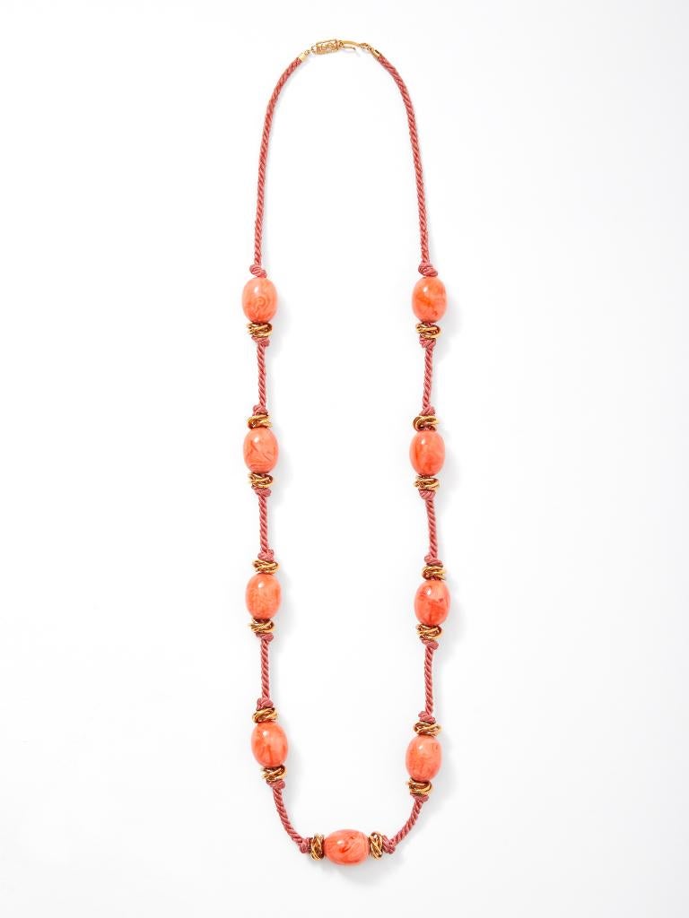 Yves Saint Laurent, Rive Gauche, coral tone, corded necklace having having  bakelite beads on knotted cord.