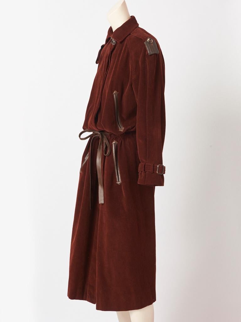 Yves Saint Laurent, Rive Gauche, oversized, corduroy and leather detailed, coat having a small pointed collar, with a leather underside,  leather lined epaulettes, drawstring waist, leather belt and leather edged slash pockets at the bust and hips.