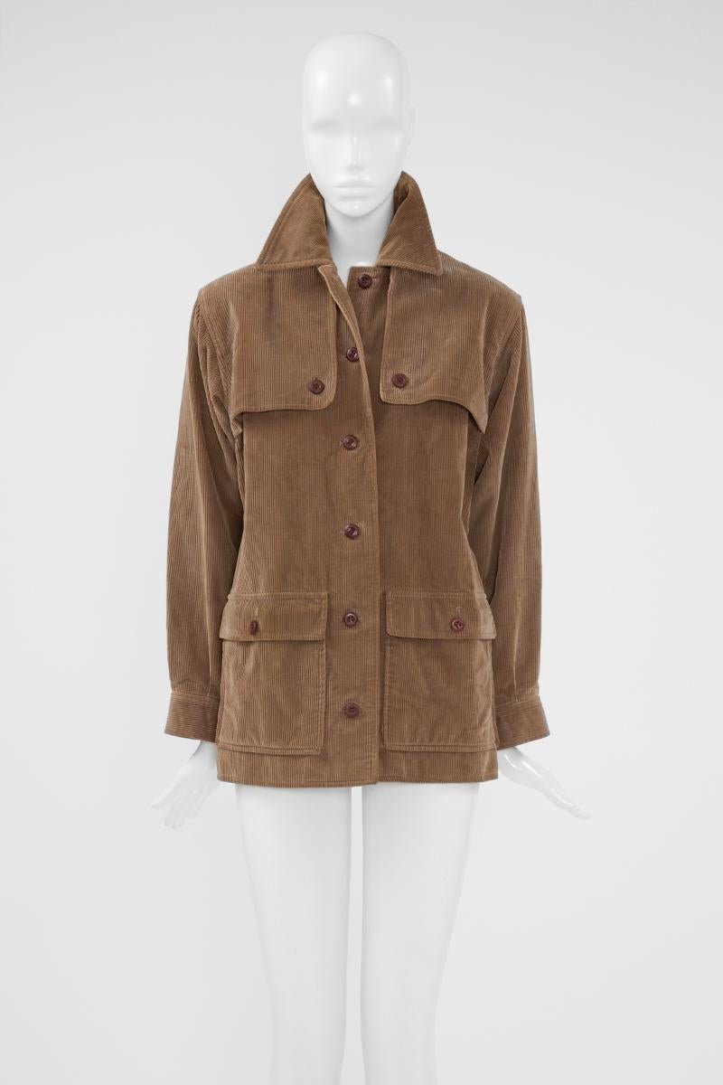 Modeled after classic utility styles, this rare Yves Saint Laurent Rive Gauche corduroy jacket features classic storm flaps, a sharp collar and pocket detail. Labelled a French size 38 (US 4-6), it runs true to size. 

Fits approx. : US 4-8 (small