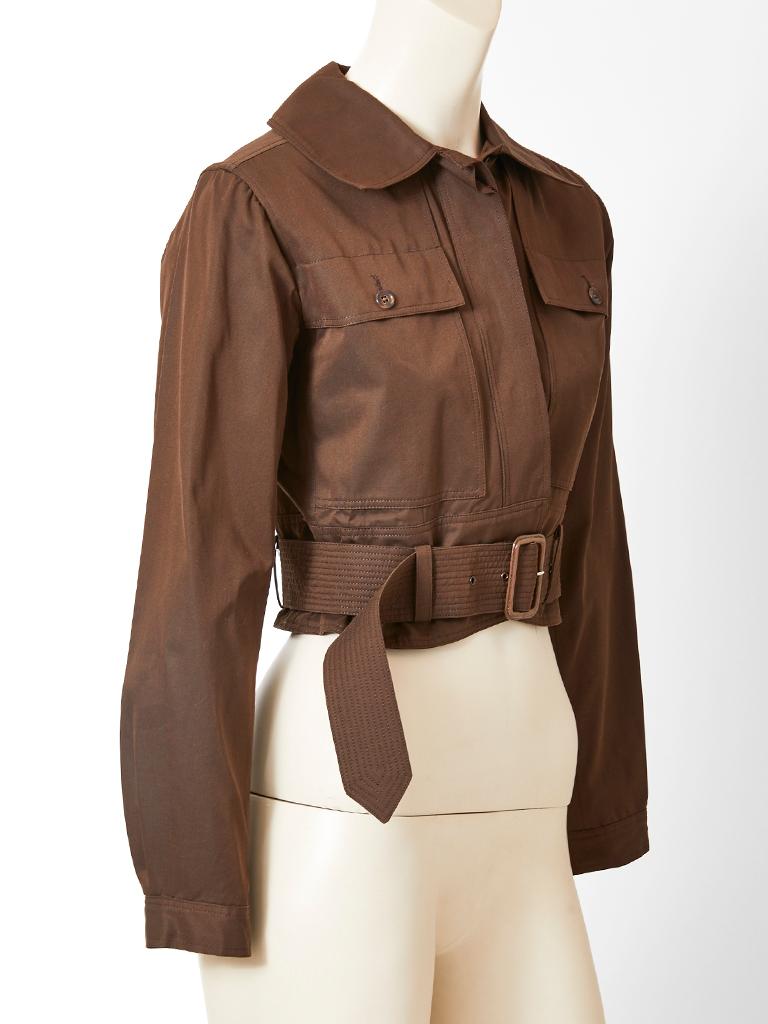 Yves Saint Laurent, Rive Gauche, chocolate brown, cotton twill, bomber jacket, having a pointed collar, 
flap breast pockets, hidden, front button closures, and an attached self belt with a buckle.