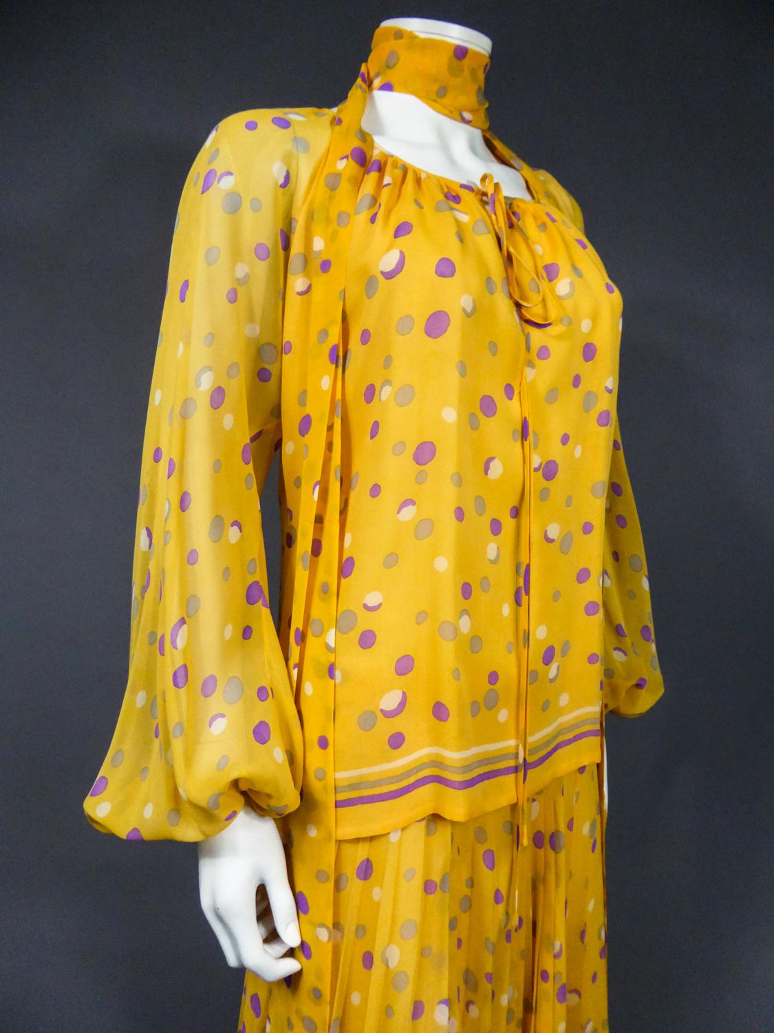Circa 1970/1975
France

Haute Couture skirt, blouse and scarf set in silk crepe printed with Modern Art patterns of the most prolific period of Yves Saint Laurent in the 1970s. Sunrise yellow printed mousseline with purple, gray and white dots